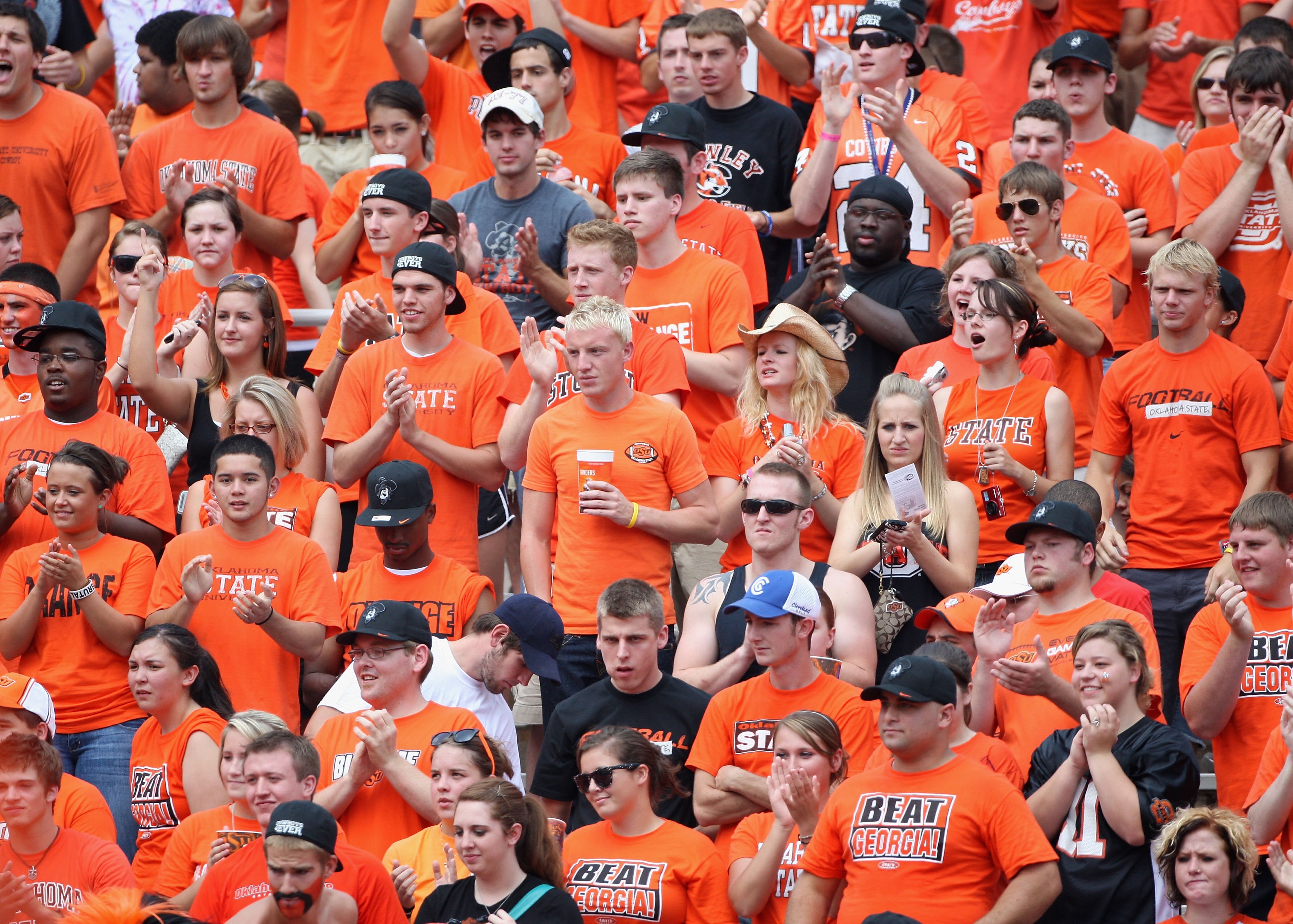 STILLWATER, OK - SEPTEMBER 05:  Fans of the Oklahoma State Cowboys cheers during the college football game against the Georgia Bulldogs at Boone Pickens Stadium on September 5, 2009 in Stillwater, Oklahoma.  The Cowboys defeated the Bulldogs 24-10.  (Phot