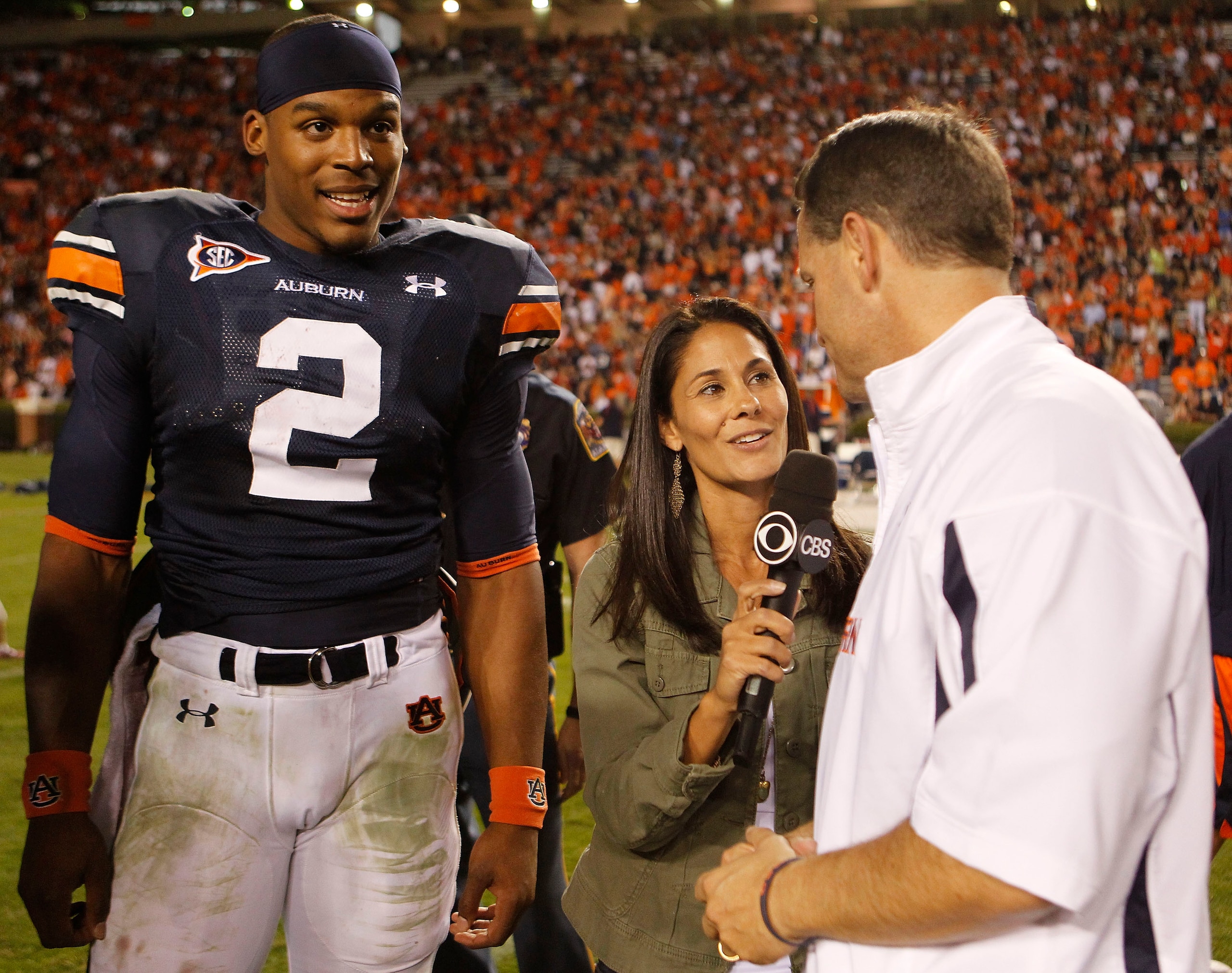 AUBURN - OCTOBER 16:  CBS sideline reporter Tracy Wolfson (center) interviews Auburn University head coach Gene Chizik (right) while Auburn Tigers quarterback Cam Newton #2 looks on after the game against the Arkansas Razorbacks at Jordan-Hare Stadium on 