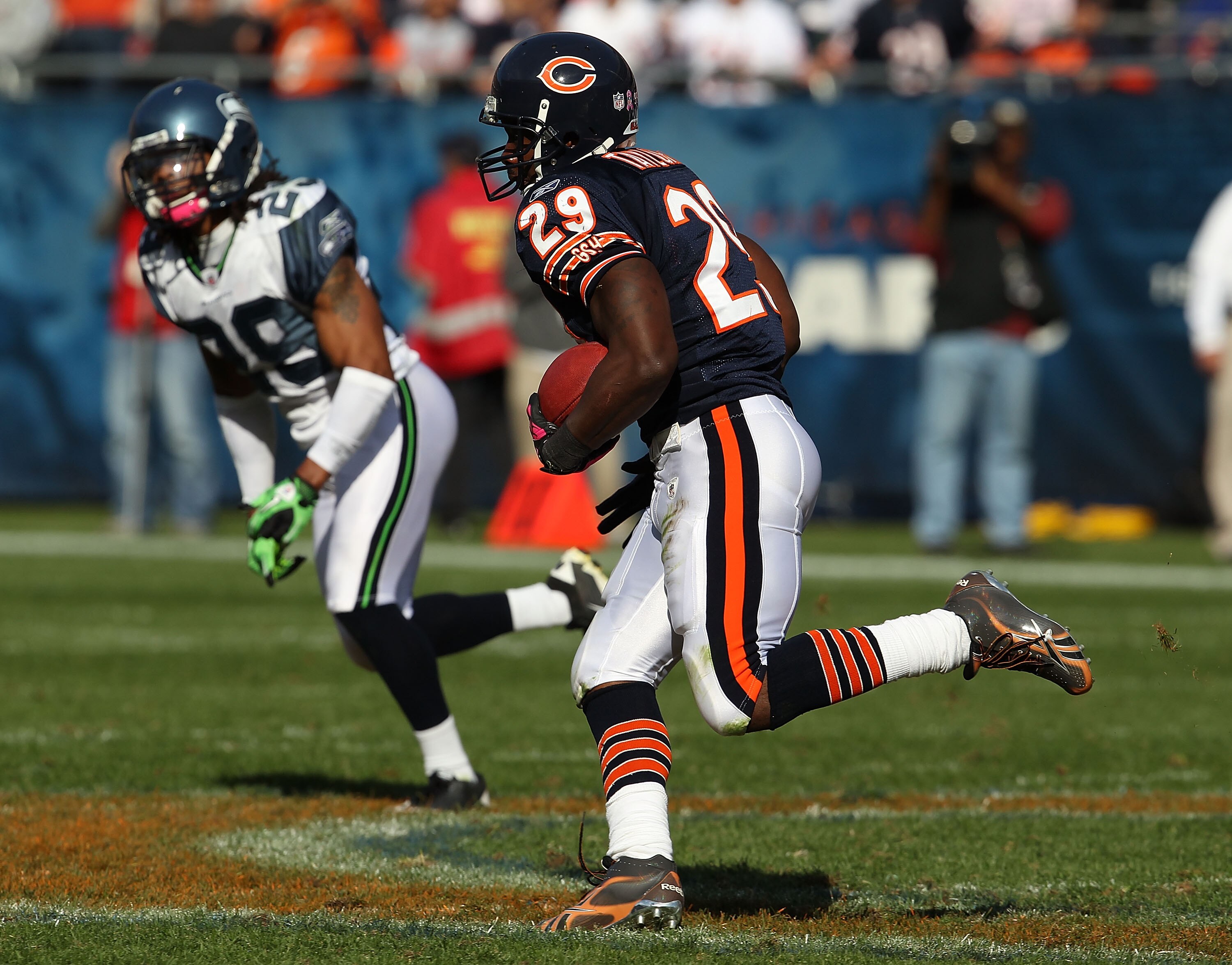 CHICAGO - OCTOBER 17: Chester Taylor #29 of the Chicago Bears runs for a first down pursued by Earl Thomas #29 of the Seattle Seahawks at Soldier Field on October 17, 2010 in Chicago, Illinois. The Seahawks defeated the Bears 23-20. (Photo by Jonathan Dan
