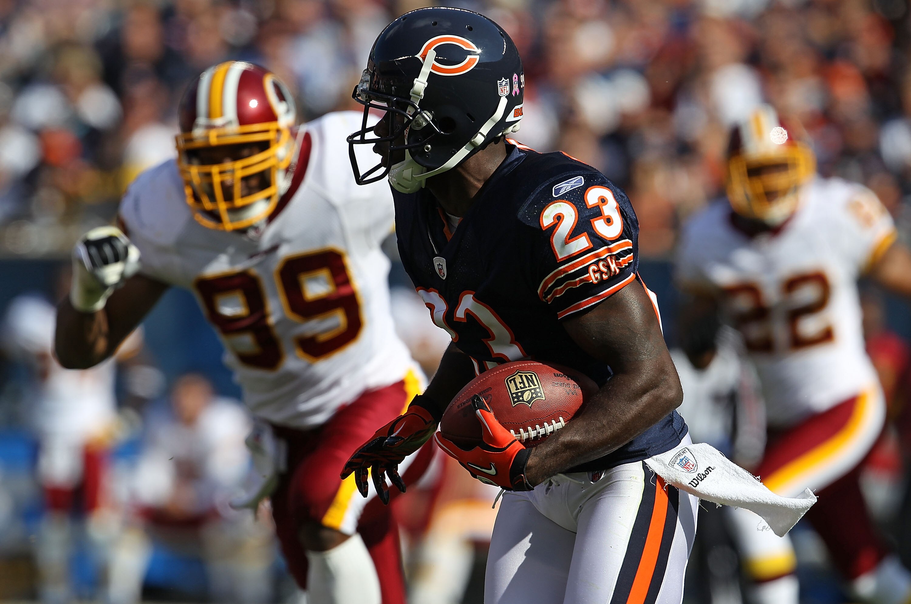 CHICAGO - OCTOBER 24: Devin Hester #23 of the Chicago Bears runs out of the 'wildcat' formation pursued by Andre Carter #99 of the Washington Redskins at Soldier Field on October 24, 2010 in Chicago, Illinois. (Photo by Jonathan Daniel/Getty Images)