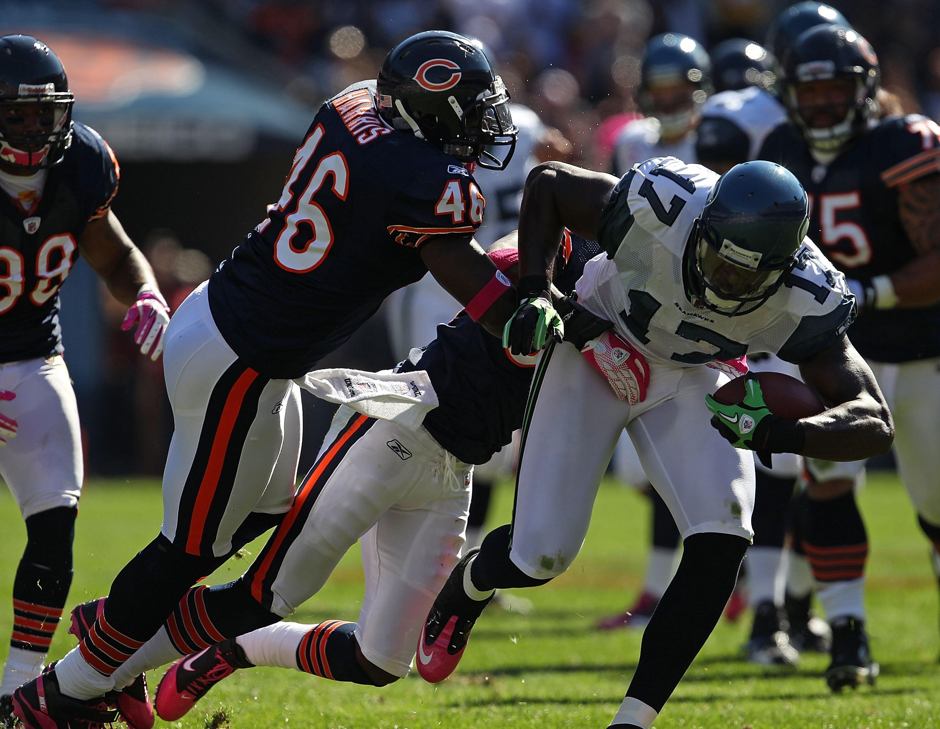 CHICAGO - OCTOBER 17: Mike Williams #17 of the Seattle Seahawks runs for a first down while being grabbed by Chris Harris #46 and Charles Tillman #33 of the Chicago Bears at Soldier Field on October 17, 2010 in Chicago, Illinois. (Photo by Jonathan Daniel