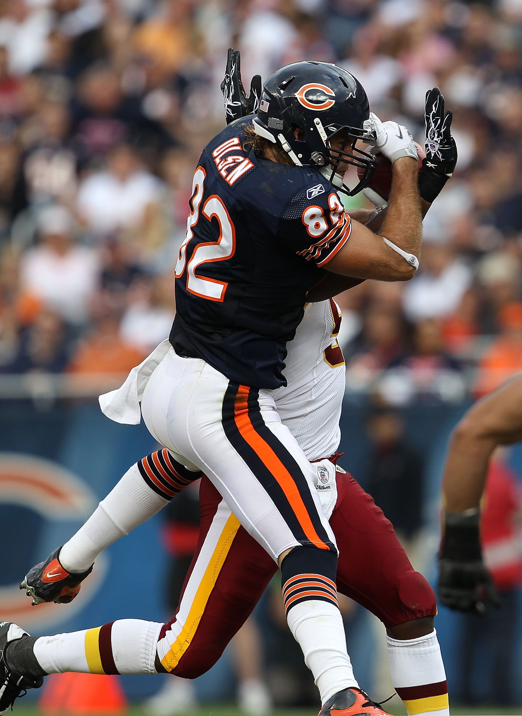 CHICAGO - OCTOBER 24: Greg Olsen #82 of the Chicago Bears catches a pass for a first down under pressure from Rocky McIntosh #52 of the Washington Redskins at Soldier Field on October 24, 2010 in Chicago, Illinois. The Redskins defeated the Bears 17-14. (