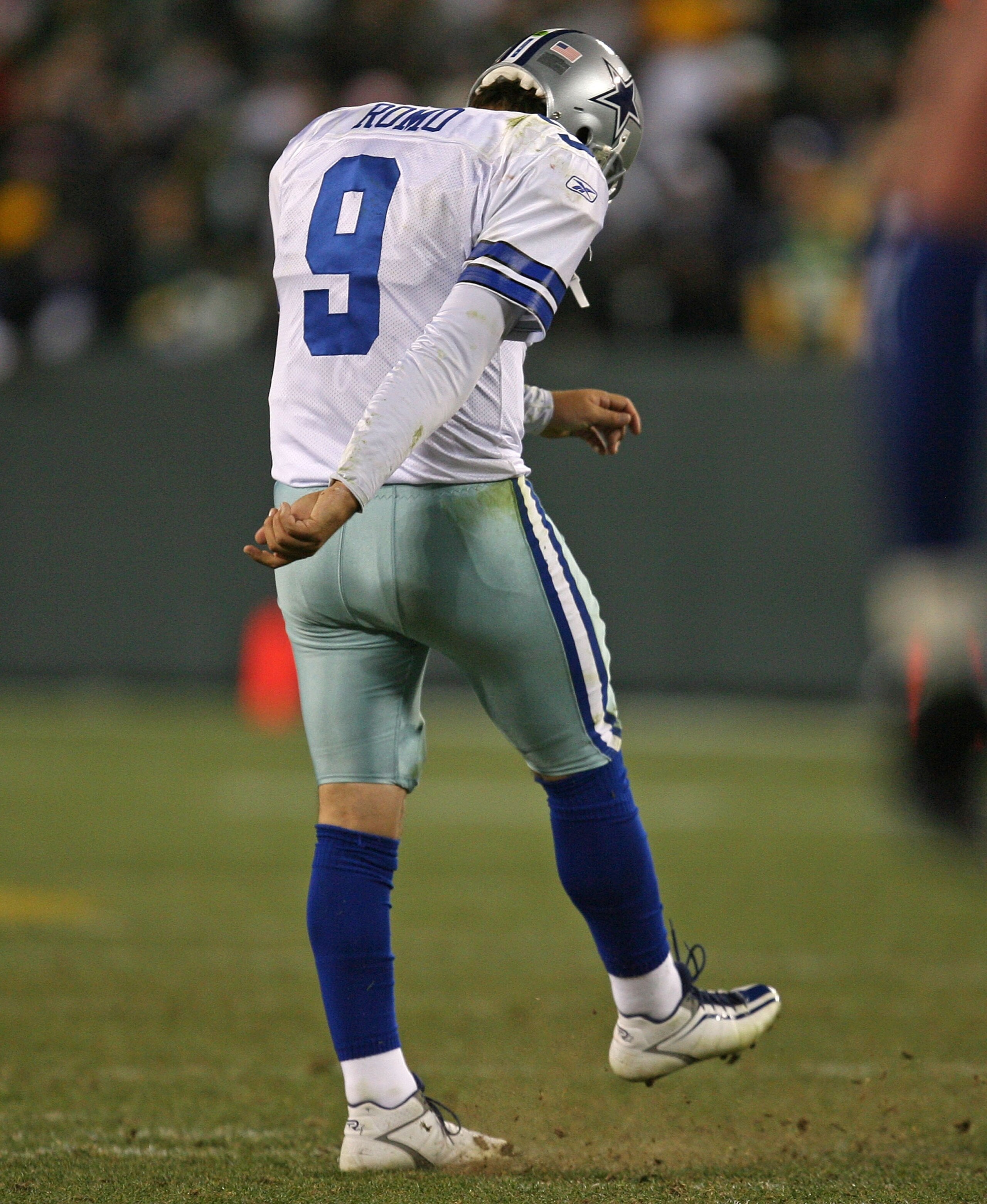 GREEN BAY, WI - NOVEMBER 15: Tony Romo #9 of the Dallas Cowboys kicks the dirt as he leaves the field after throwing an interception at the goal line against the Green Bay Packers at Lambeau Field on November 15, 2009 in Green Bay, Wisconsin. The Packers