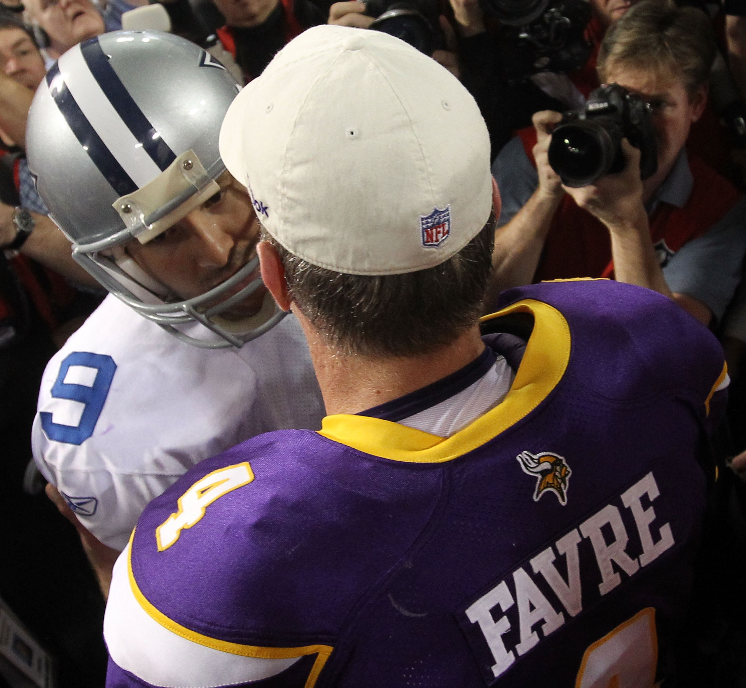 MINNEAPOLIS - JANUARY 17:  Quarterback Tony Romo #9 of the Dallas Cowboys congratulates quarterback Brett Favre #4 of the Minnesota Vikings on their 34-3 victory during the NFC Divisional Playoff Game at Hubert H. Humphrey Metrodome on January 17, 2010 in