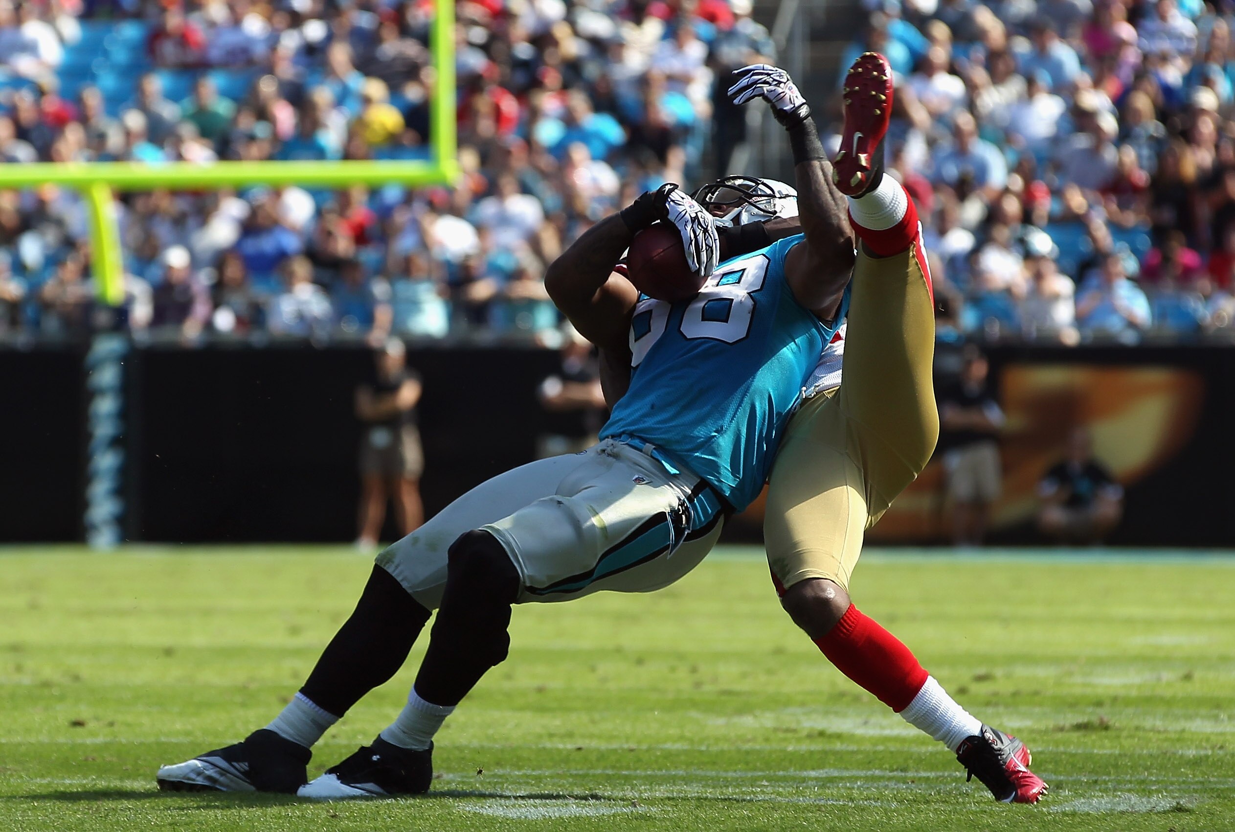 CHARLOTTE, NC - OCTOBER 24:  Dashon Goldson #38 of the San Francisco 49ers tackles Dante Rosario #88 of the Carolina Panthers during their game at Bank of America Stadium on October 24, 2010 in Charlotte, North Carolina.  (Photo by Streeter Lecka/Getty Im