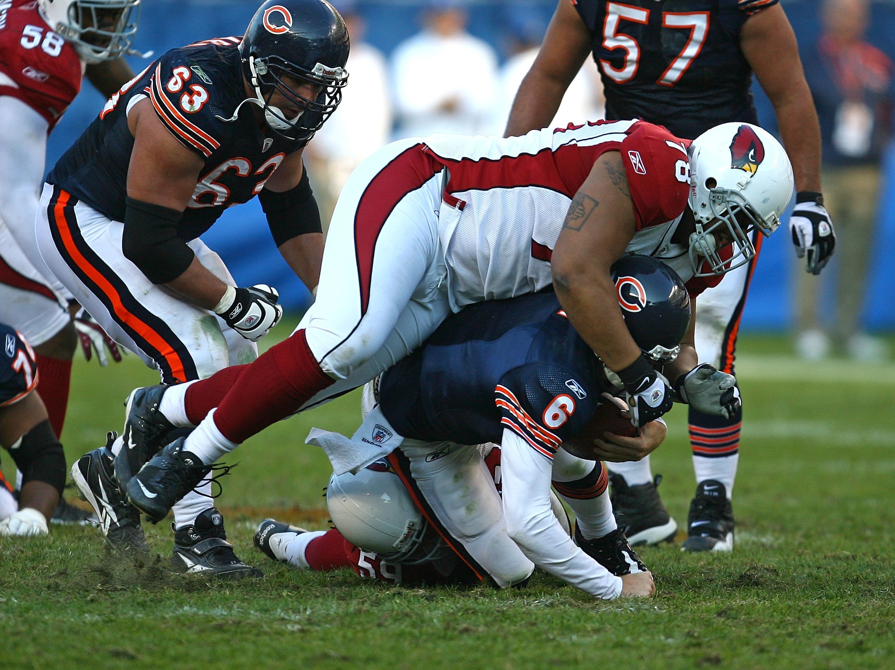 CHICAGO - NOVEMBER 08: Jay Cutler #6 of the Chicago Bears is sacked by Will Davis #59 and flattened by Alan Branch #78 of the Arizona Cardinals at Soldier Field on November 8, 2009 in Chicago, Illinois. The Cardinals defeated the Bears 41-21.  (Photo by J