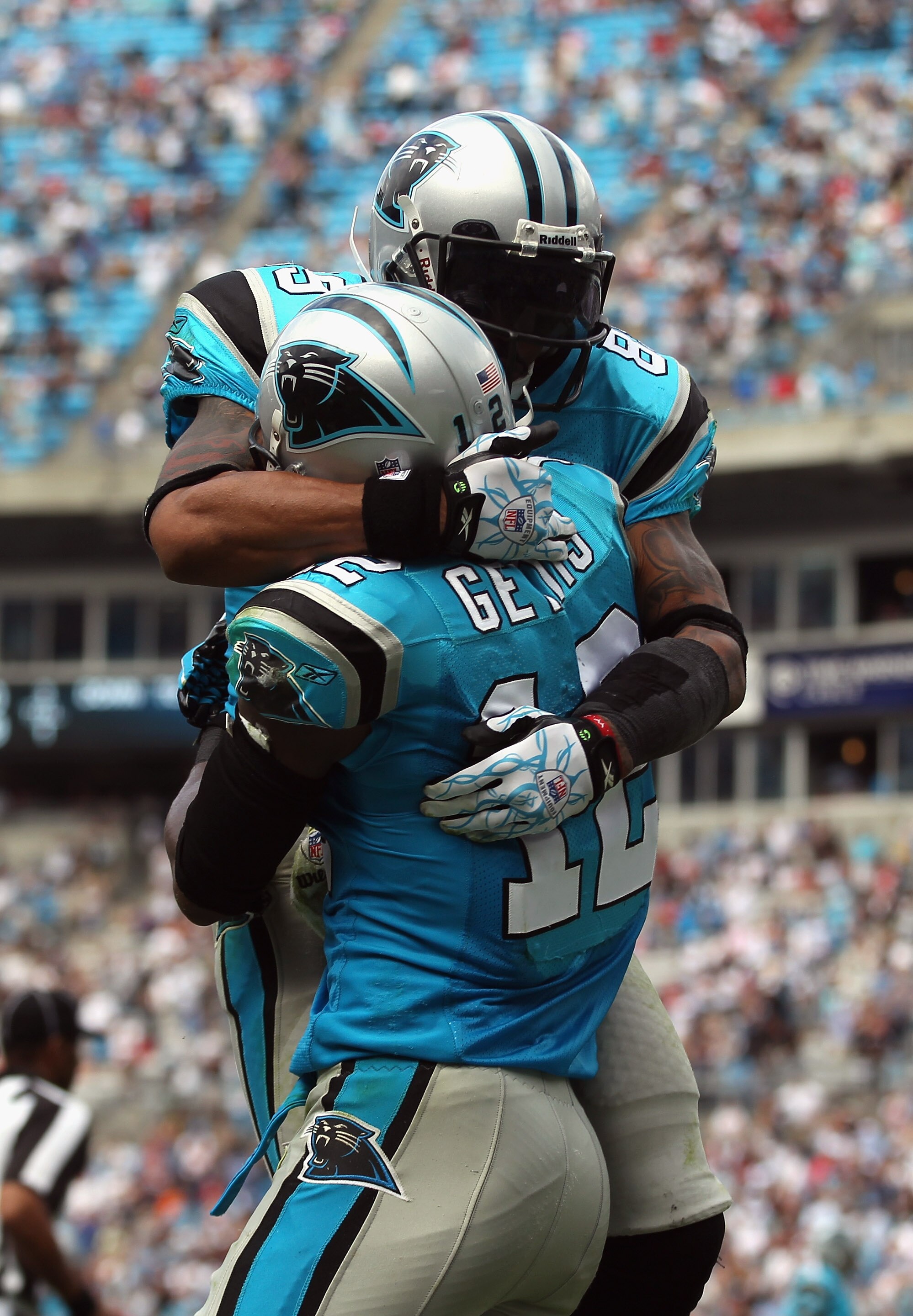 CHARLOTTE, NC - OCTOBER 24:  Teammates Steve Smith #89 and David Gettis #12 of the Carolina Panthers celebrate after Gettis scored a touchdown late in the fourth quarter against the San Francisco 49ers during their game at Bank of America Stadium on Octob