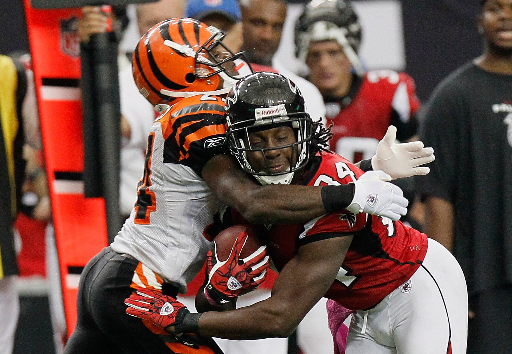 ATLANTA - OCTOBER 24:  Roddy White #84 of the Atlanta Falcons collides with Adam Jones #24 of the Cincinnati Bengals before having the ball stripped for a touchdown by Jones at Georgia Dome on October 24, 2010 in Atlanta, Georgia.  (Photo by Kevin C. Cox/