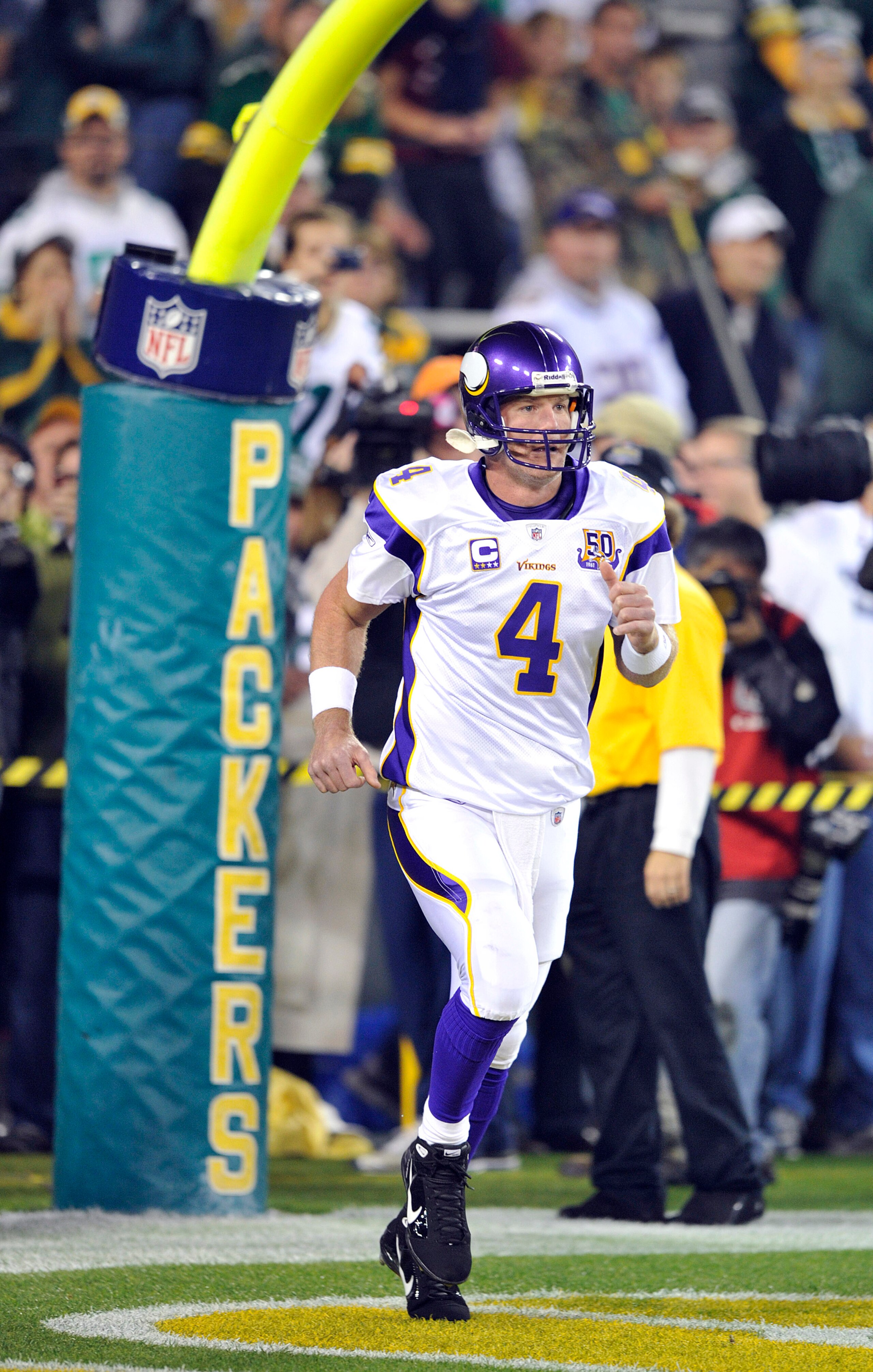 GREEN BAY, WI - OCTOBER 24:  Brett Favre #4 of the Minnesota Vikings runs on the field for pregame warmups against the Green Bay Packers at Lambeau Field on October 24, 2010 in Green Bay, Wisconsin. ( Jim Prisching/ Getty Images)