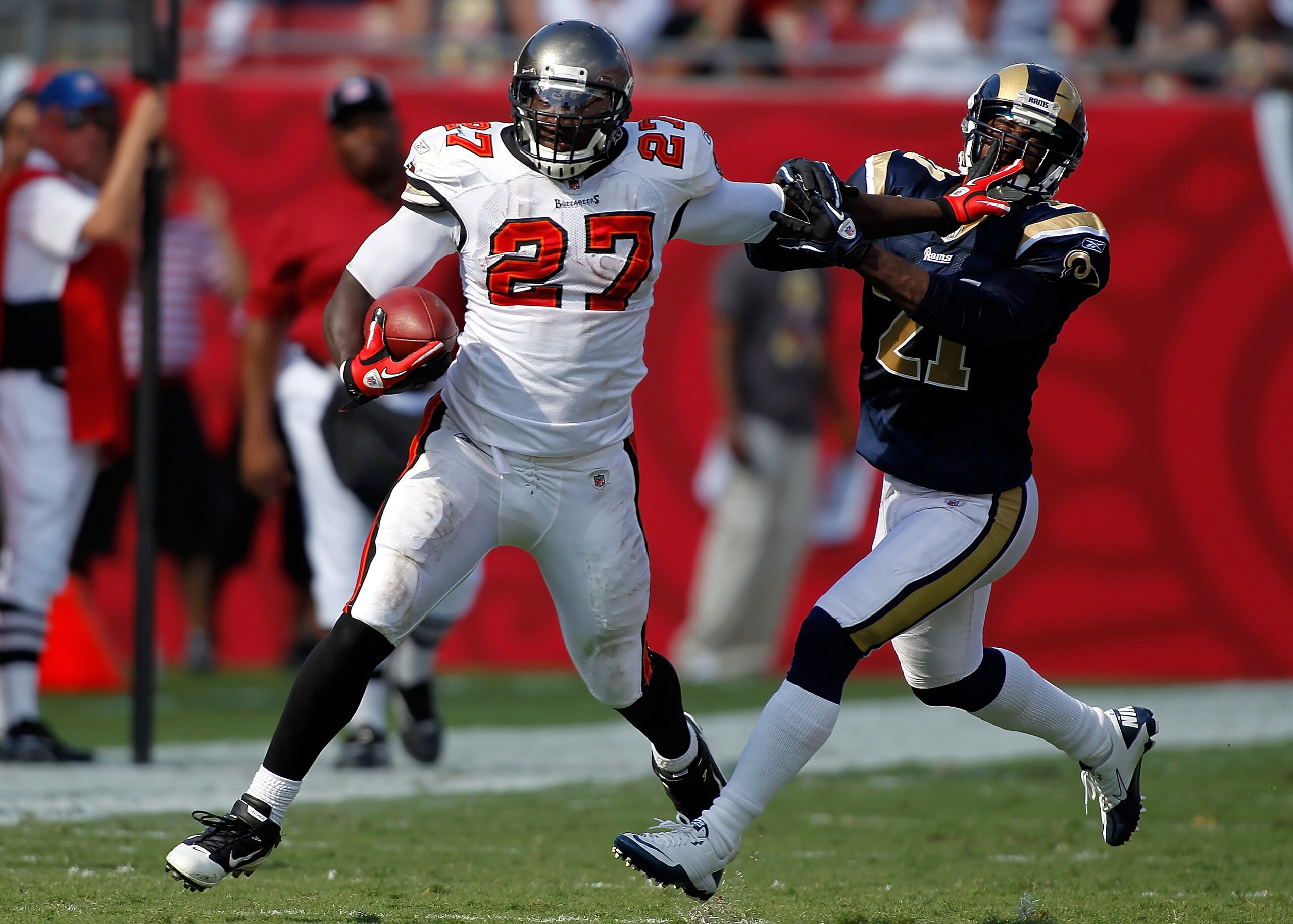 TAMPA, FL - OCTOBER 24:  Running back LeGarrette Blount #27 of the Tampa Bay Buccaneers straight arms safety Oshiomogho Atogwe #21 of the St. Louis Rams during the game at Raymond James Stadium on October 24, 2010 in Tampa, Florida.  (Photo by J. Meric/Ge