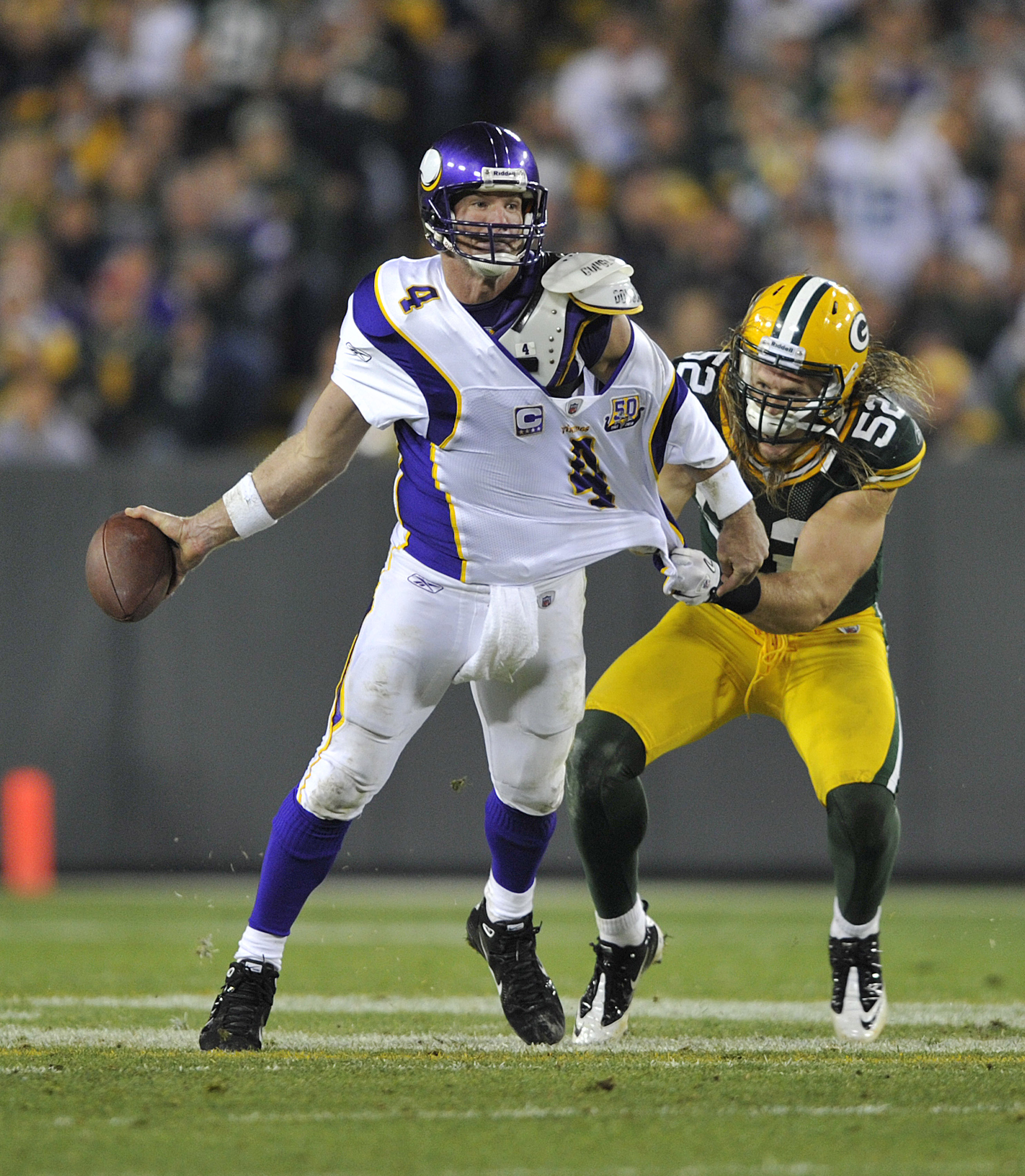 GREEN BAY, WI - OCTOBER 24:  Brett Favre #4 of the Minnesota Vikings has his jersey grabbed by Clay Matthews #52 of the Green Bay Packers at Lambeau Field on October 24, 2010 in Green Bay, Wisconsin. (Photo by Jim Prisching/Getty Images)