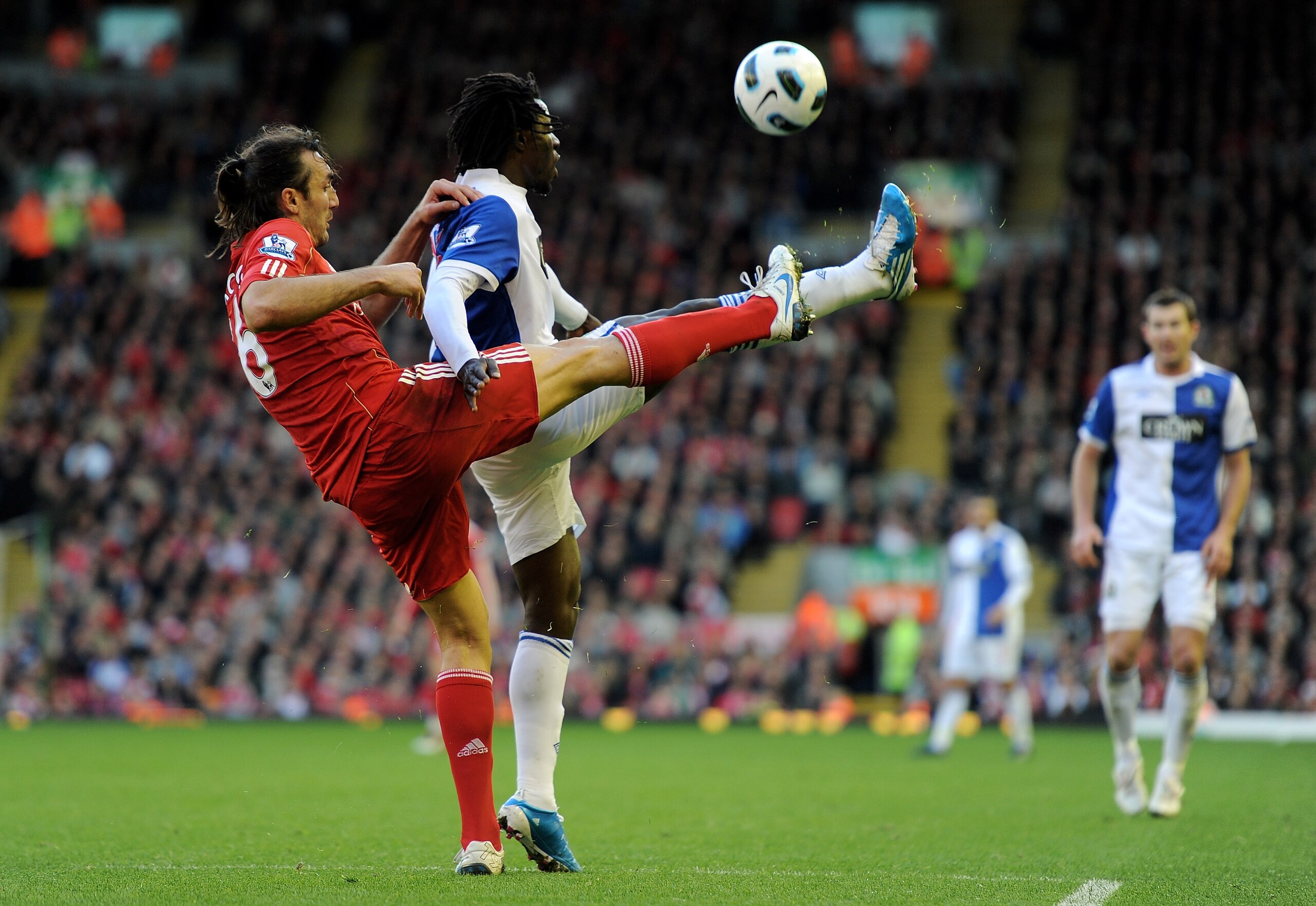 LIVERPOOL, ENGLAND - OCTOBER 24:  Sotiros Kyrgiakos of Liverpool competes with Benjani of Blackburn Rovers during the Barclays Premier League match between Liverpool and Blackburn Rovers at Anfield on October 24, 2010 in Liverpool, England. (Photo by Mich