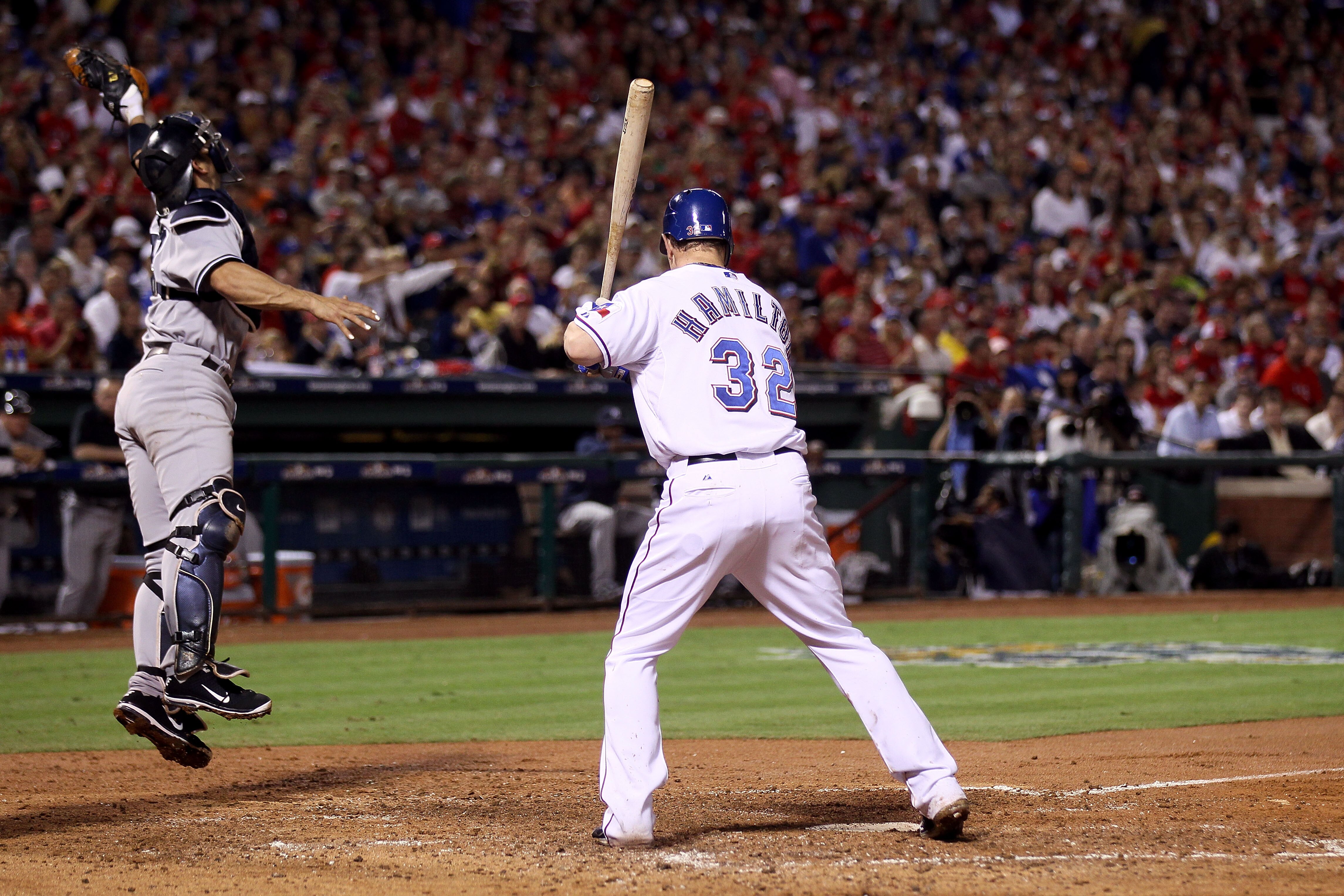 ARLINGTON, TX - OCTOBER 22:  Jorge Posada #20 of the New York Yankees jumps at a wild pitch from Phil Hughes #65 during an at bat by Josh Hamilton #32 of the Texas Rangers in the third inning of Game Six of the ALCS during the 2010 MLB Playoffs at Rangers