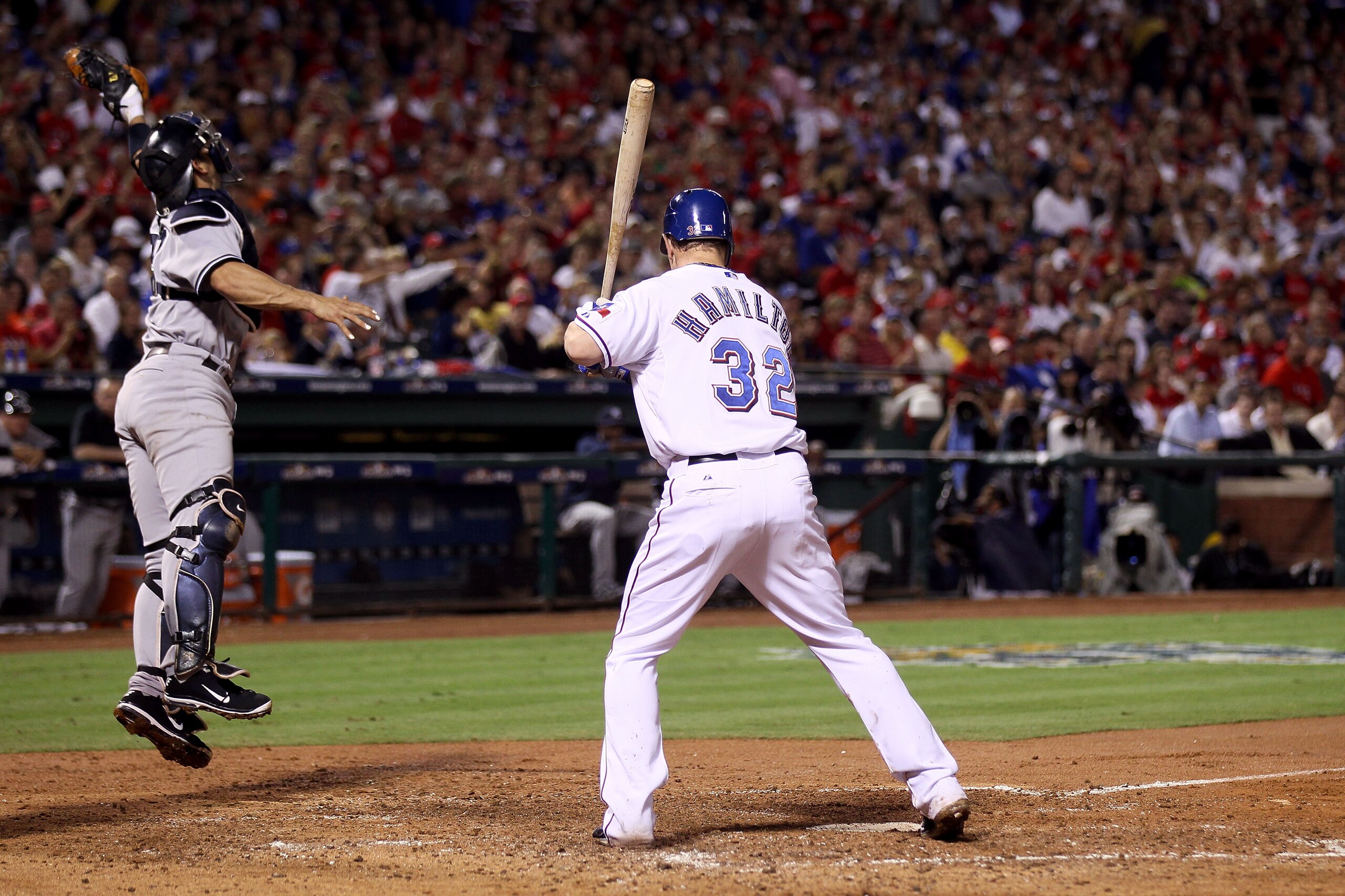 ARLINGTON, TX - OCTOBER 22:  Jorge Posada #20 of the New York Yankees jumps at a wild pitch from Phil Hughes #65 during an at bat by Josh Hamilton #32 of the Texas Rangers in the third inning of Game Six of the ALCS during the 2010 MLB Playoffs at Rangers