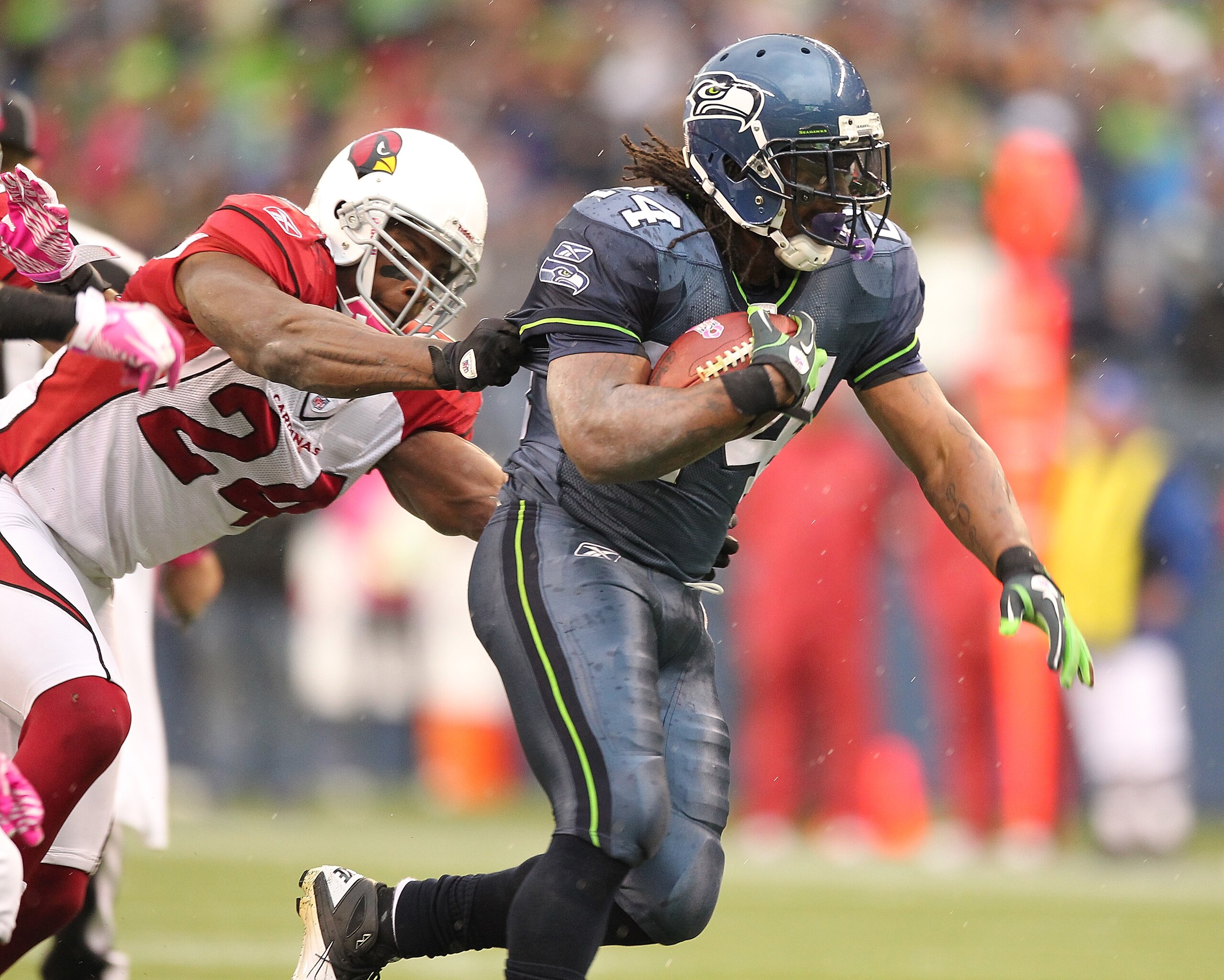 SEATTLE - OCTOBER 24:  Running back Marshawn Lynch #24 of the Seattle Seahawks rushes against Adrian Wilson #24 of the Arizona Cardinals at Qwest Field on October 24, 2010 in Seattle, Washington. The Seahawks defeated the Cardinals 22-10. (Photo by Otto G