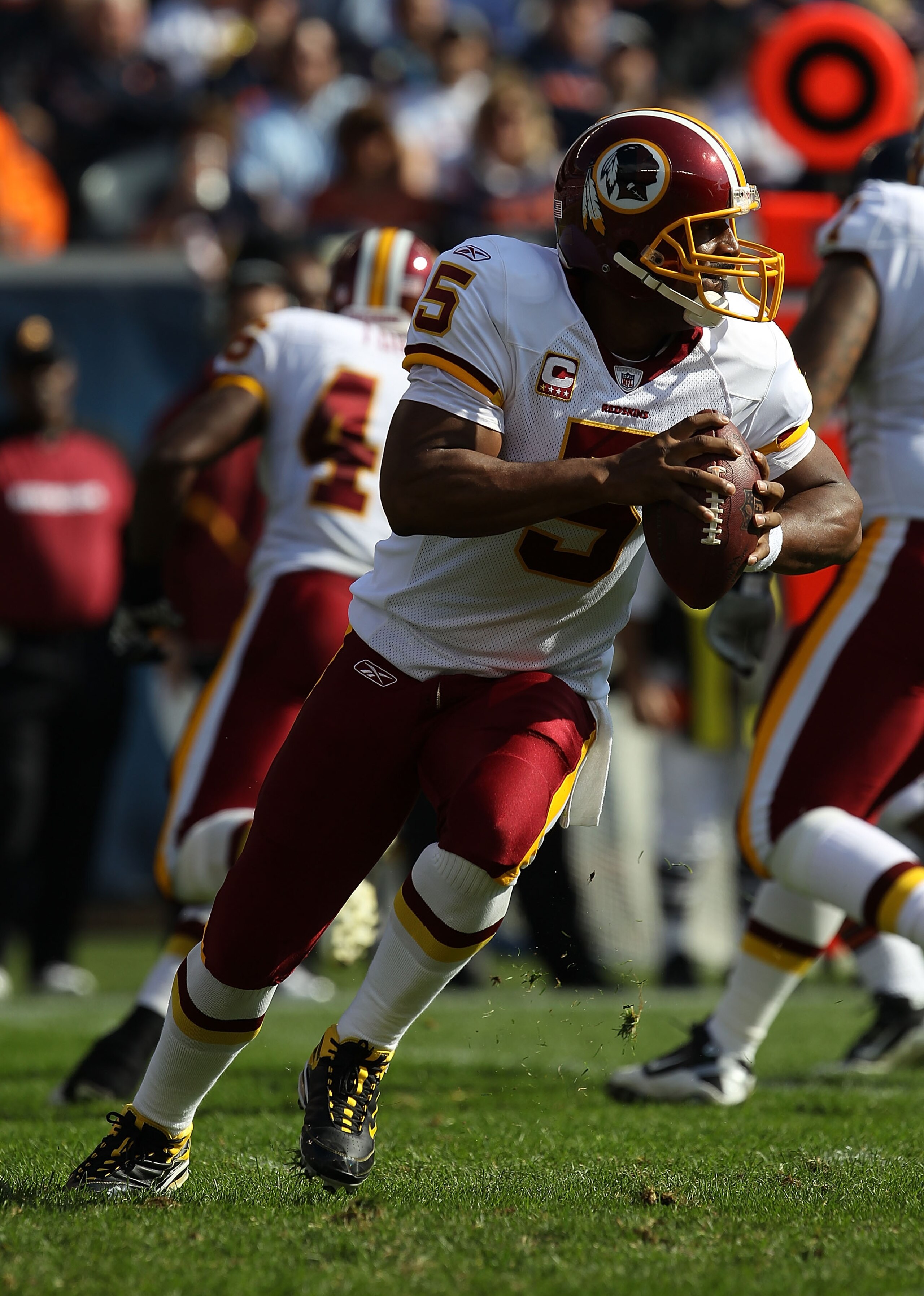 CHICAGO - OCTOBER 24: Donovan McNabb #5 of the Washington Redskins rolls out to look for a receiver against the Chicago Bears at Soldier Field on October 24, 2010 in Chicago, Illinois.  The Redskins defeated the Bears 17-14. (Photo by Jonathan Daniel/Gett