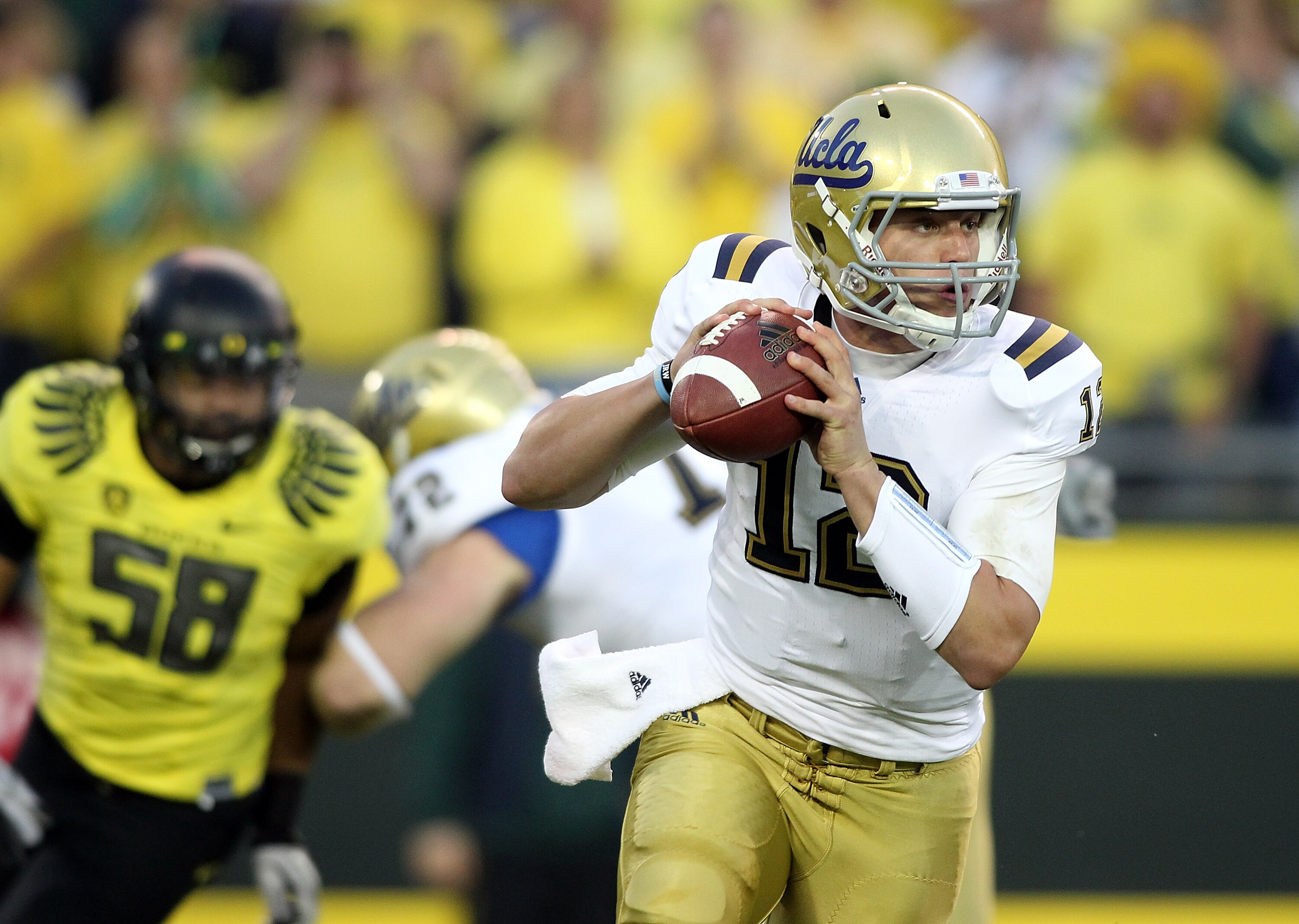 EUGENE, OR - OCTOBER 21:  Richard Brehaut #12 of the UCLA Bruins  scrambles out of the pocket against the Oregon Ducks on October 21, 2010 at the Autzen Stadium in Eugene, Oregon.  (Photo by Jonathan Ferrey/Getty Images)