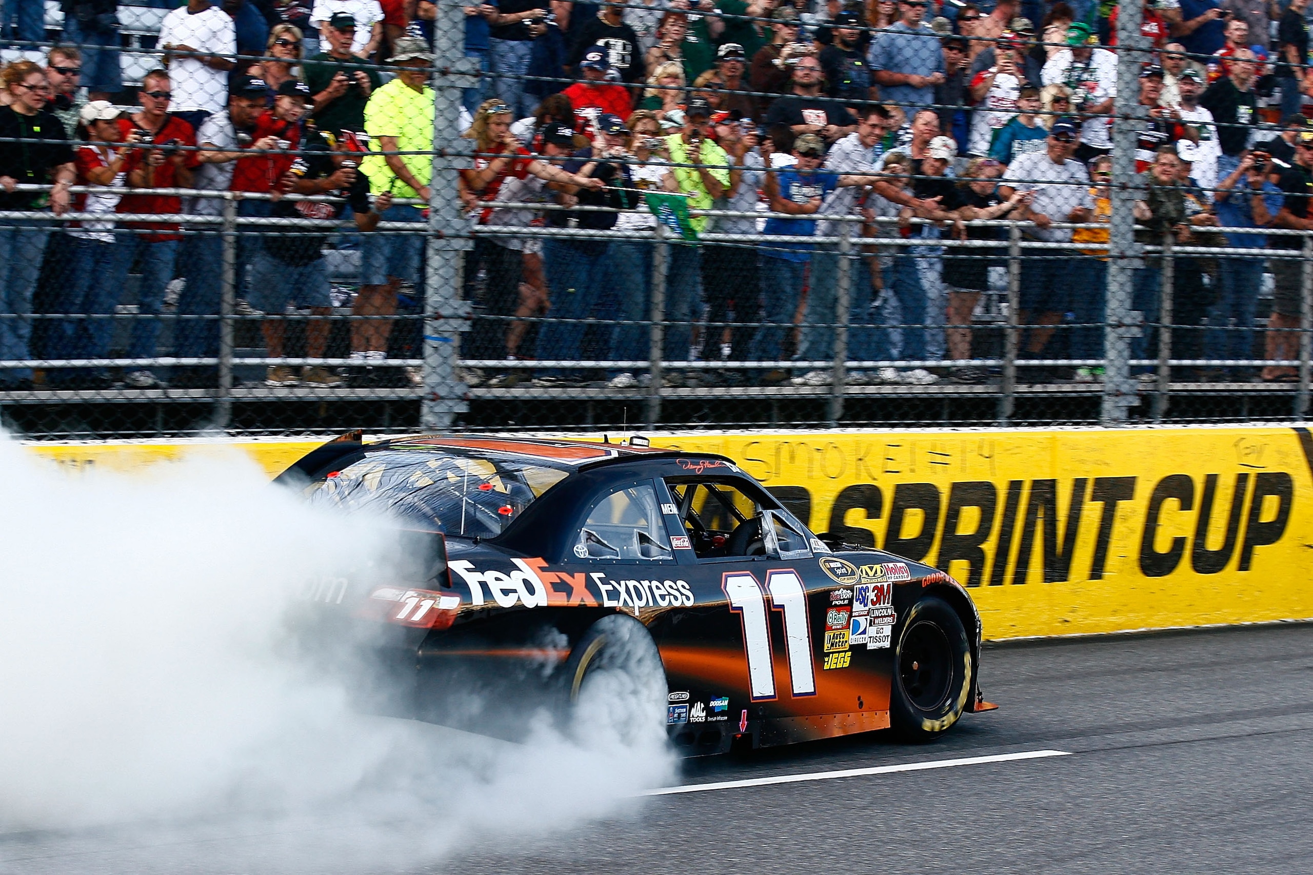 MARTINSVILLE, VA - OCTOBER 24:  Denny Hamlin, driver of the #11 FedEx Express Toyota, burnsout after winning the NASCAR Sprint Cup Series TUMS Fast Relief 500 at Martinsville Speedway on October 24, 2010 in Martinsville, Virginia.  (Photo by Jason Smith/G