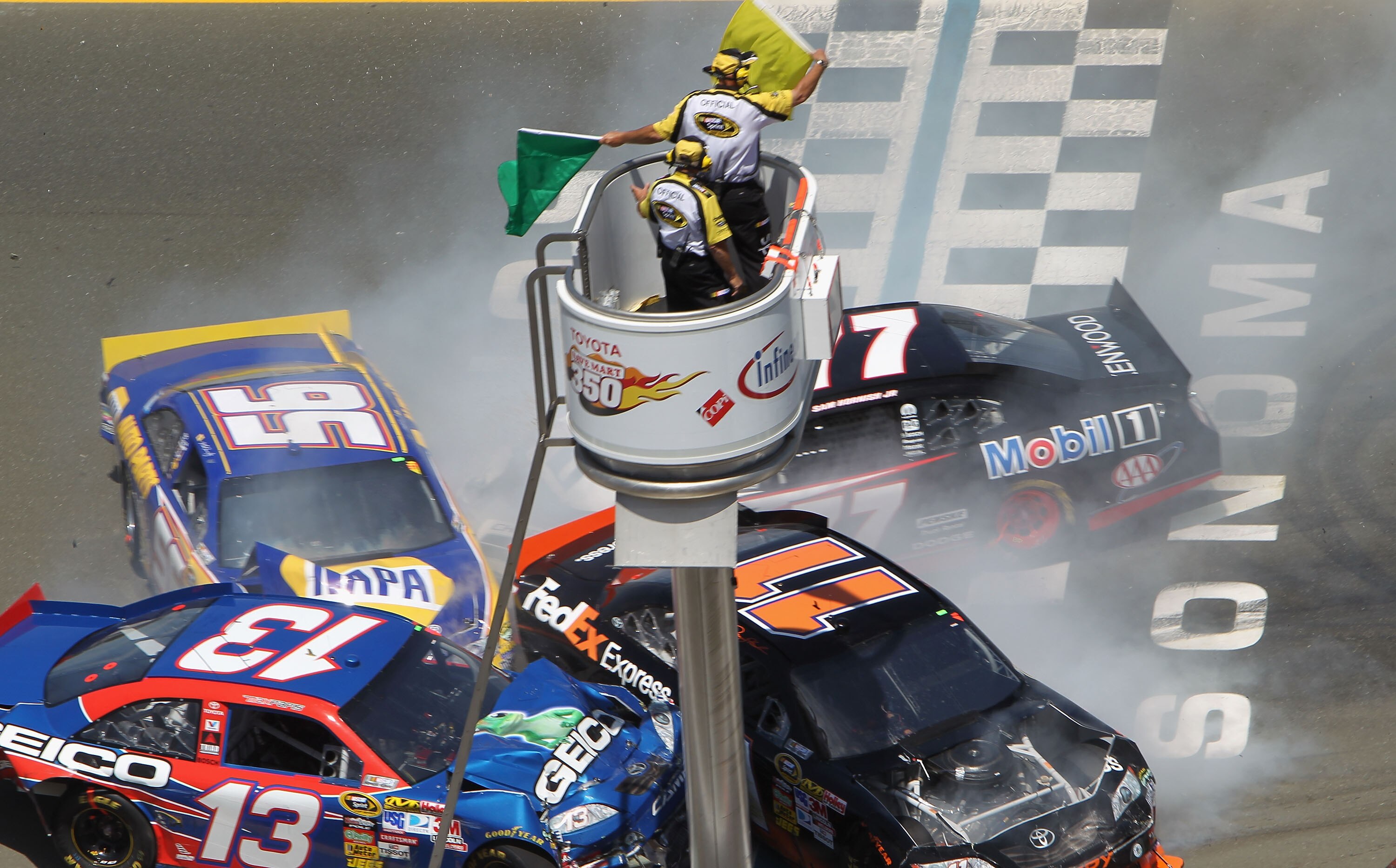 SONOMA, CA - JUNE 20:  Martin Truex Jr., driver of the #56 NAPA Toyota, Denny Hamlin, driver of the #11 FedEx Toyota, Max Papis, driver of the #13 Geico Toyota, and Sam Hornish Jr., driver of the #77 Mobil 1 Dodge, crash during a restart in the NASCAR Spr