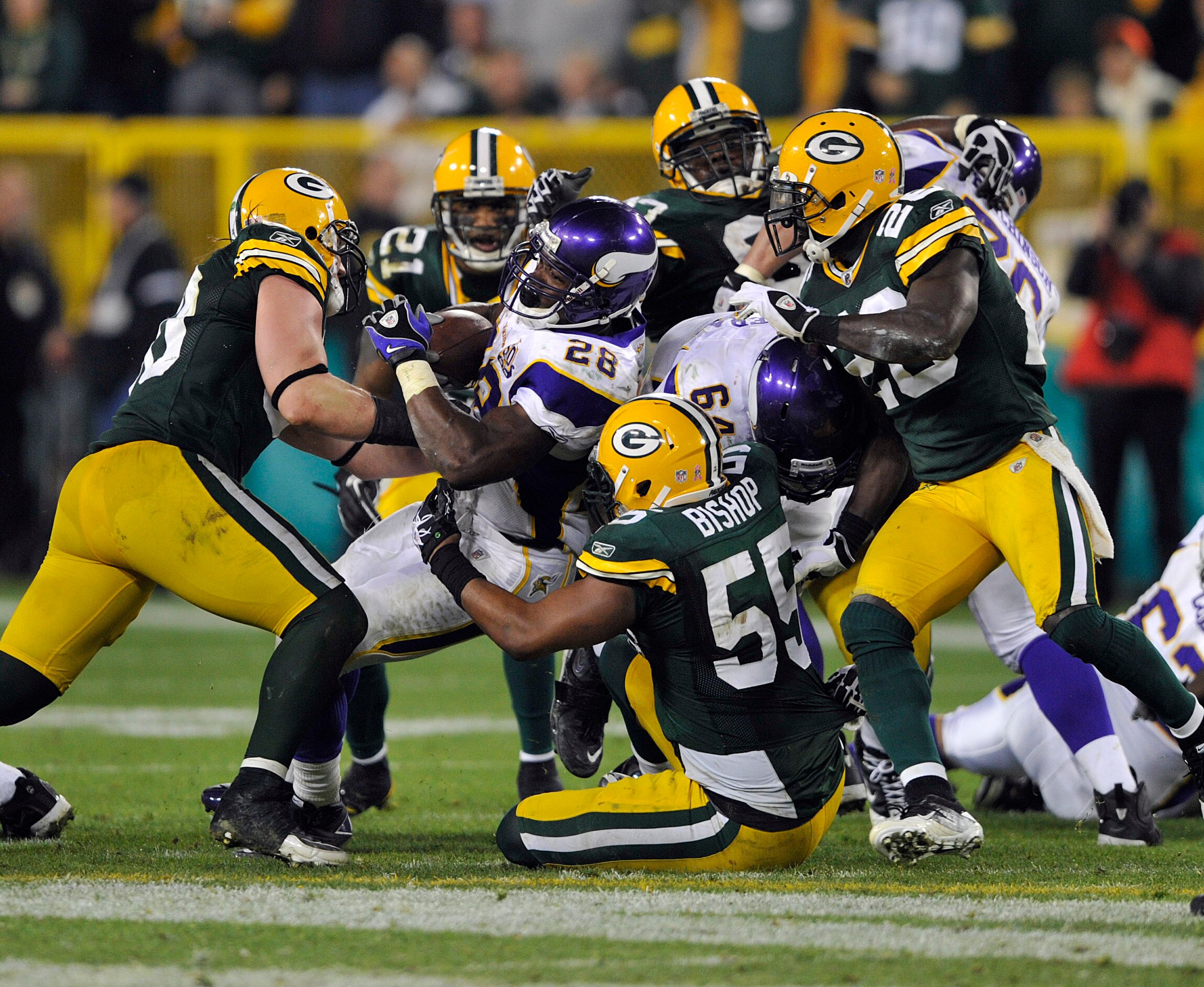 GREEN BAY, WI - OCTOBER 24:  Adrian Peterson #28 of the Minnesota Vikings is stopped by Desmond Bishop #55 of the Green Bay Packers at Lambeau Field on October 24, 2010 in Green Bay, Wisconsin. (Photo by Jim Prisching/Getty Images)