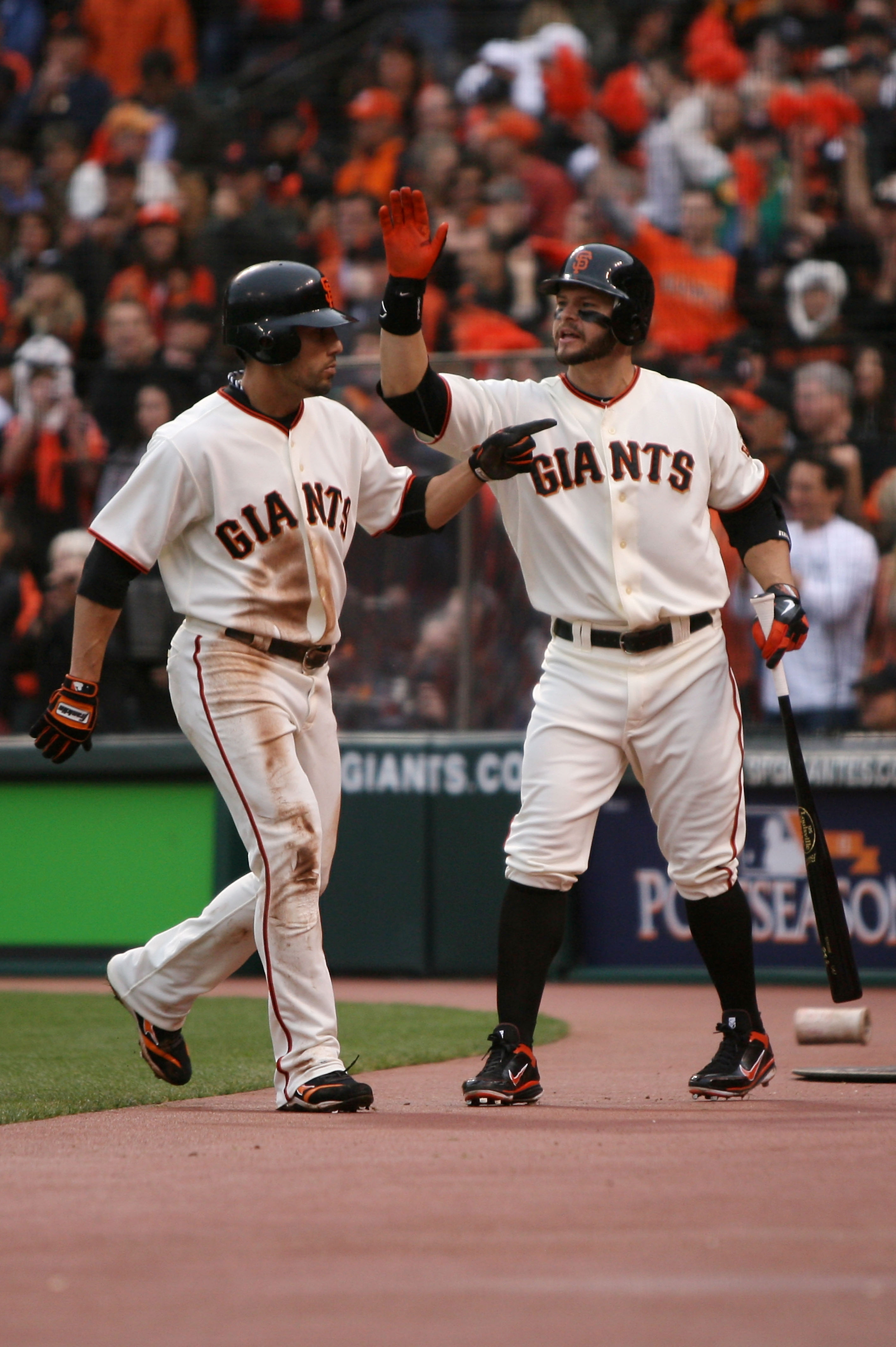 SAN FRANCISCO - OCTOBER 21:  (L-R) Andres Torres #56 of the San Francisco Giants celebrates with Cody Ross #13 after scoring in the first inning against the Philadelphia Phillies in Game Five of the NLCS during the 2010 MLB Playoffs at AT&T Park on Octobe