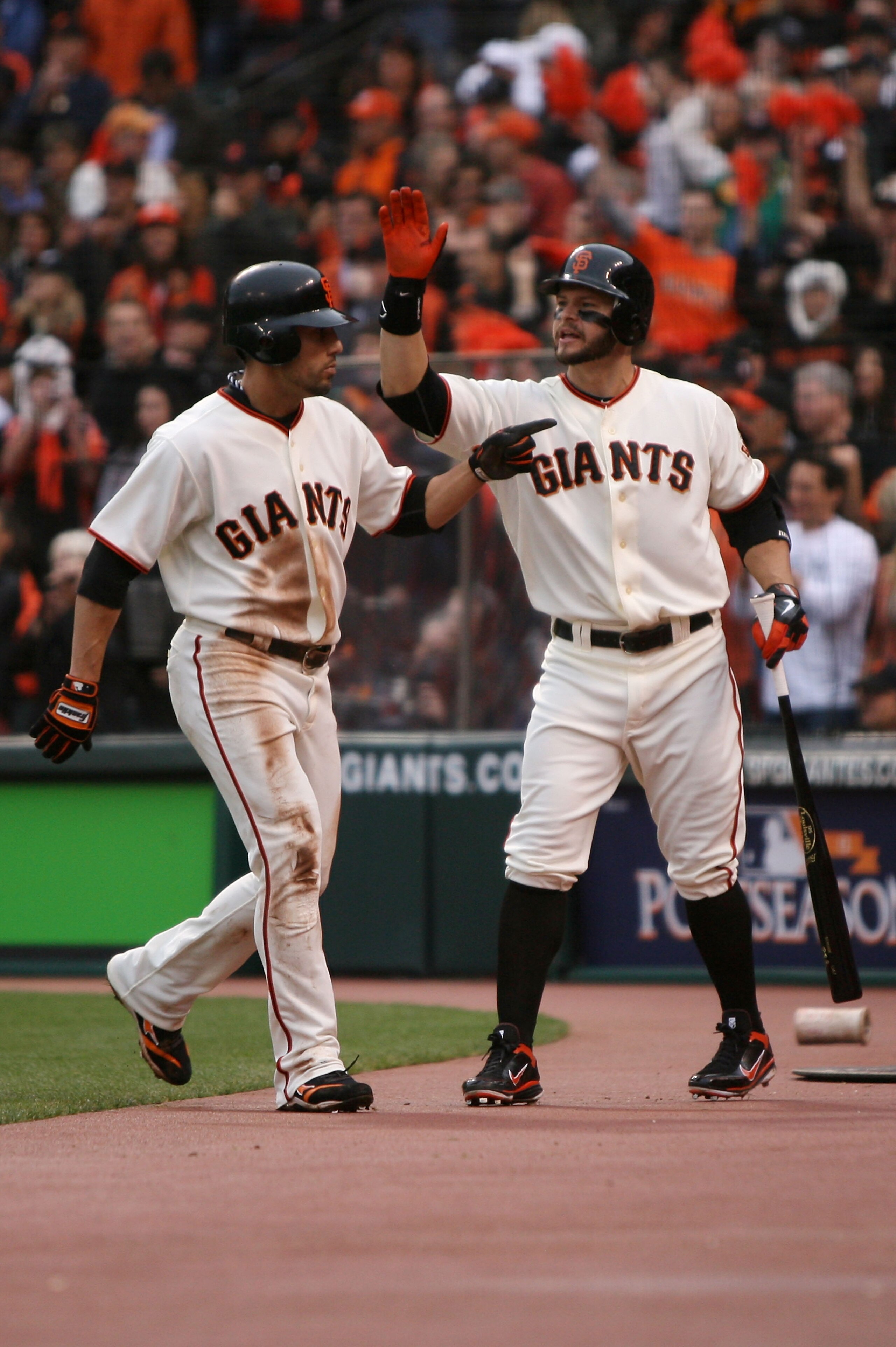SAN FRANCISCO - OCTOBER 21:  (L-R) Andres Torres #56 of the San Francisco Giants celebrates with Cody Ross #13 after scoring in the first inning against the Philadelphia Phillies in Game Five of the NLCS during the 2010 MLB Playoffs at AT&T Park on Octobe