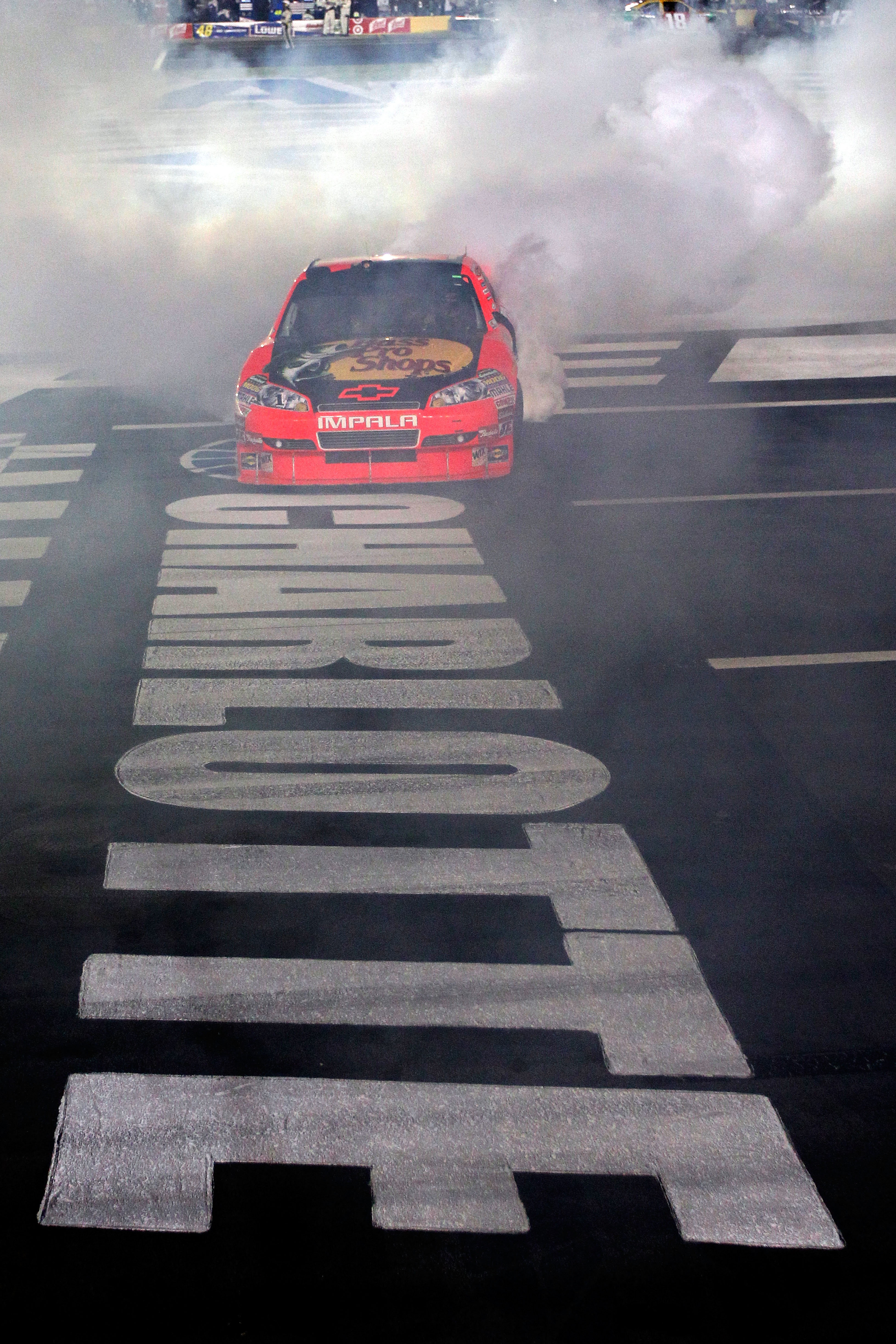CONCORD, NC - OCTOBER 16:  Jamie McMurray, driver of the #1 Bass Pro Shops/Tracker Boats Chevrolet, does a burnout after winning the NASCAR Sprint Cup Series Bank of America 500 at Charlotte Motor Speedway on October 16, 2010 in Concord, North Carolina.