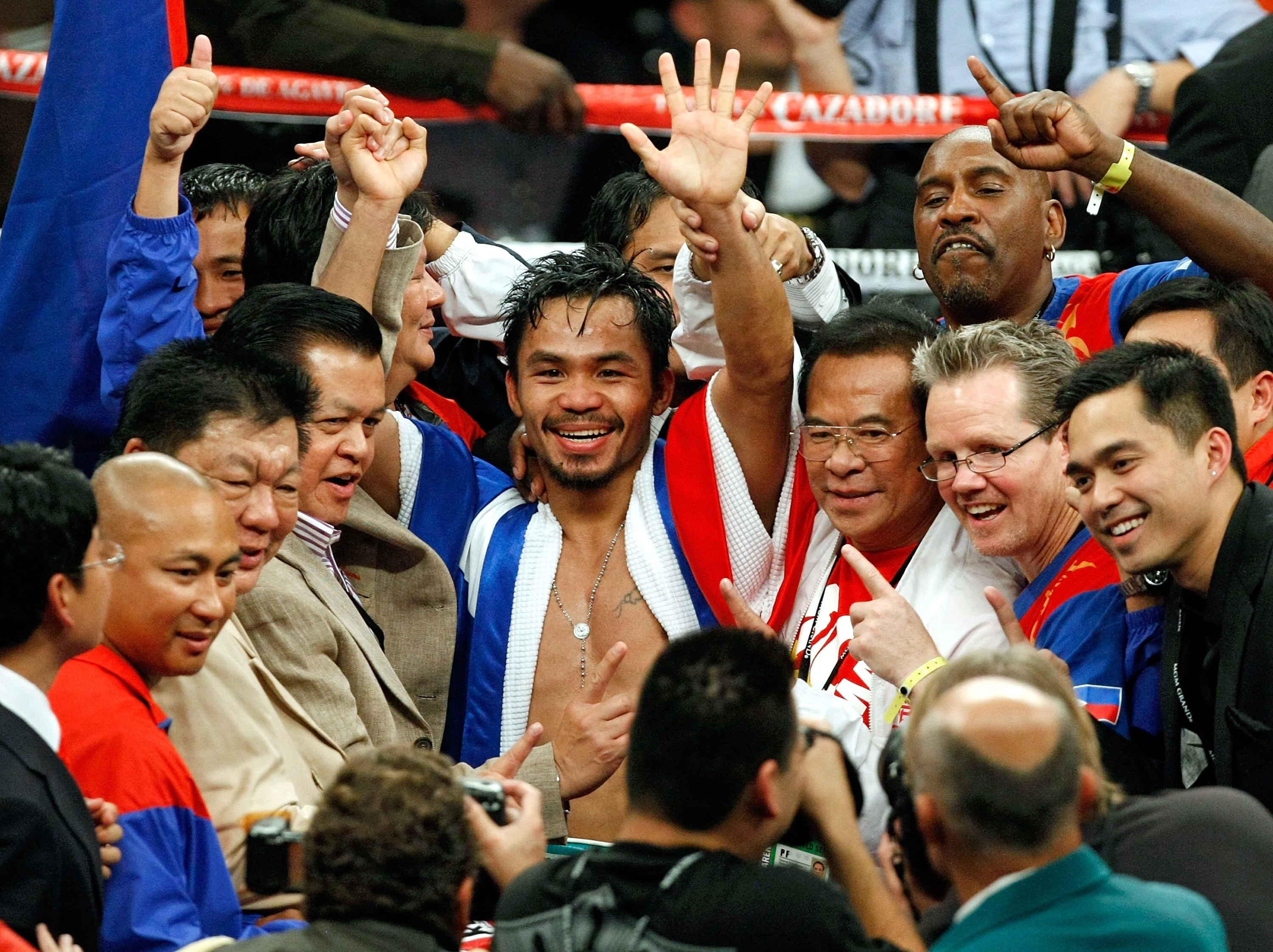 LAS VEGAS - DECEMBER 06:  Manny Pacquiao of the Philippines and his team celebrate his victory over Oscar De La Hoya in their welterweight bout at the MGM Grand Garden Arena December 6, 2008 in Las Vegas, Nevada.  (Photo by Ethan Miller/Getty Images)
