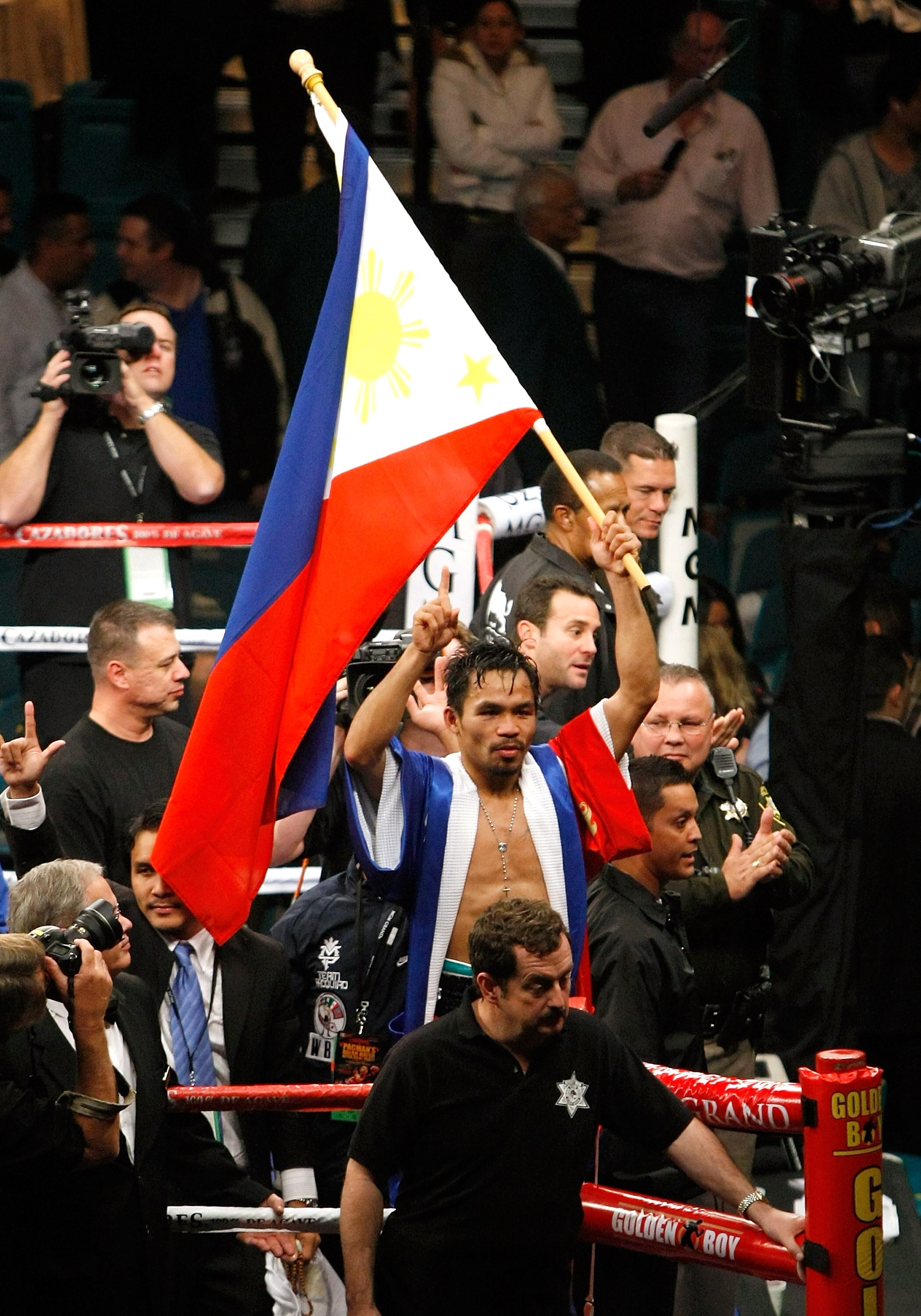 LAS VEGAS - DECEMBER 06:  Manny Pacquiao waves the flag of the Philippines in the ring as he celebrates his victory over Oscar De La Hoya in their welterweight bout at the MGM Grand Garden Arena December 6, 2008 in Las Vegas, Nevada.  (Photo by Ethan Mill