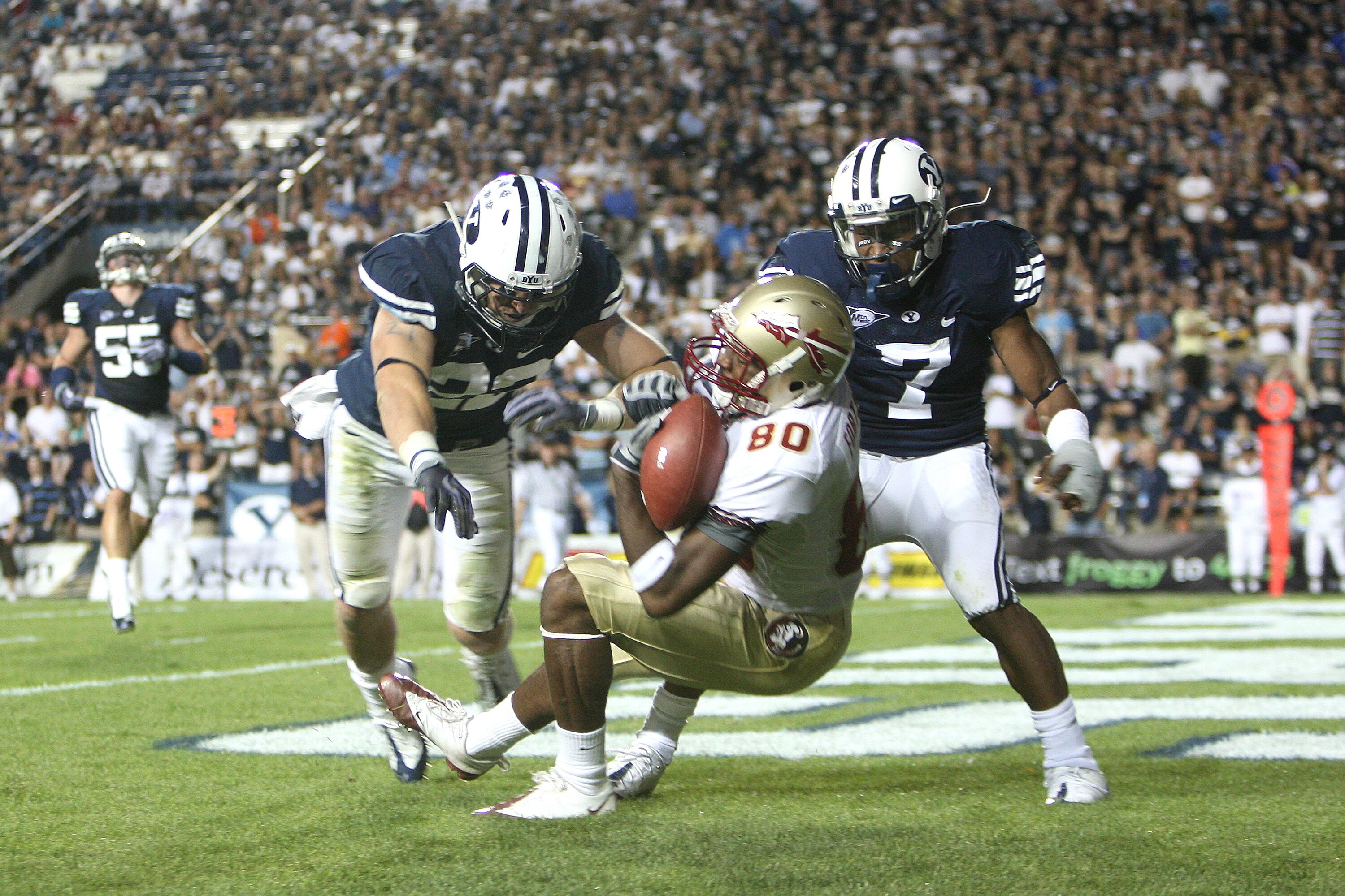 PROVO, UT. - SEPTEMBER 19:  Jarmon Fortson #80 of the Florida State Seminoles gets the touchdown against Andrew Rich #22 and Brian Logan #7 of the Brigham Young Cougars at La Vell Edwards Stadium on September 19, 2009 in Provo, Utah.  (Photo by Melissa Ma