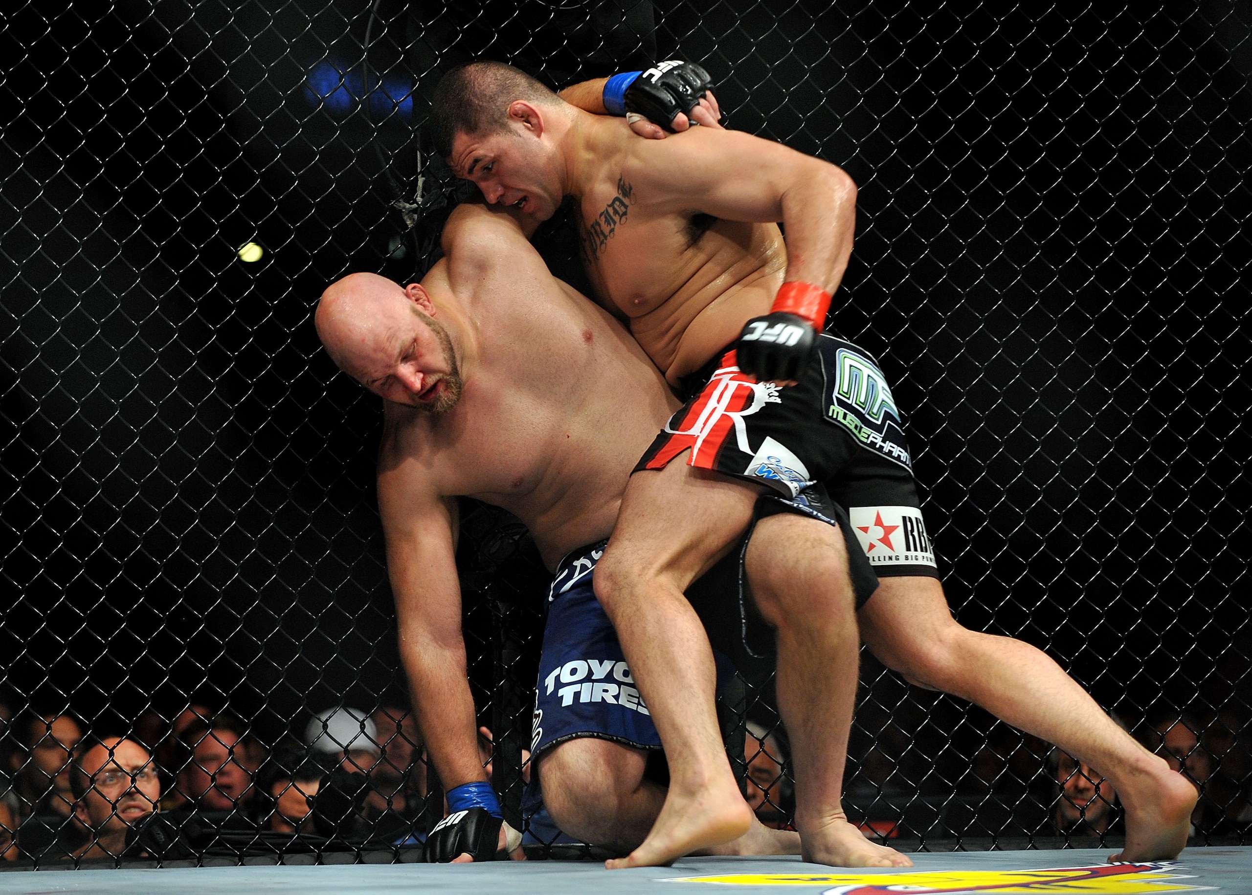 LOS ANGELES, CA - OCTOBER 24: UFC fighter Cain Velasquez (R) hits UFC fighter Ben Rothwell (L) up against the fence during their Heavyweight bout at UFC 104: Machida vs. Shogun at Staples Center on October 24, 2009 in Los Angeles, California. Velasquez LOS ANGELES, CA - OCTOBER 24: UFC fighter Cain Velasquez (R) hits UFC fighter Ben Rothwell (L) up against the fence during their Heavyweight bout at UFC 104: Machida vs. Shogun at Staples Center on October 24, 2009 in Los Angeles, California. Velasquez
