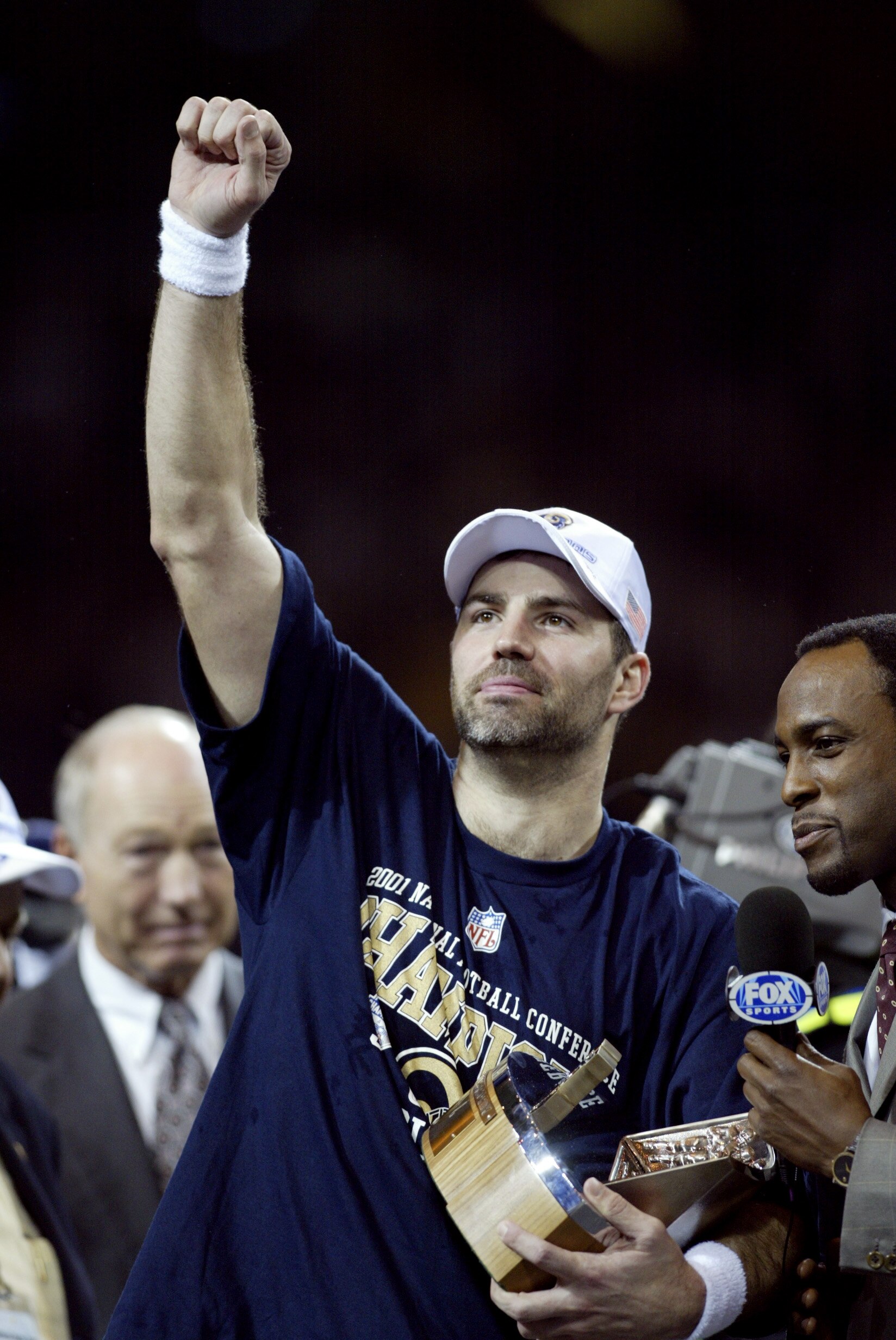 27 Jan 2002:  Quarterback Kurt Warner #13 of the St.Louis Rams holds the George Hallas Trophy after the NFC Championship Game against the Philadelphia Eagles  at the Dome at America's Center in St. Louis, Missouri. The Rams beat the  Eagles 29-24 to advan