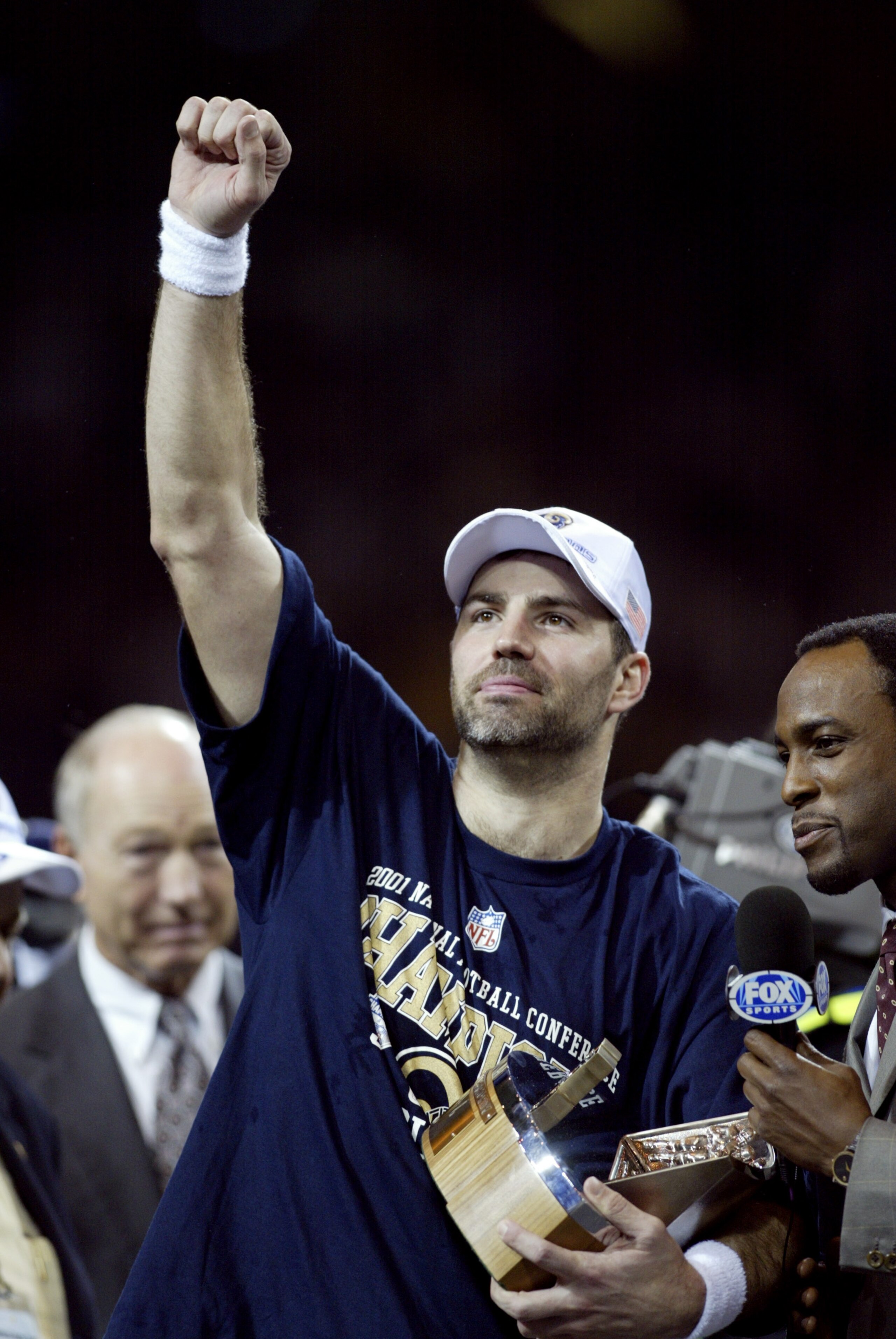 27 Jan 2002:  Quarterback Kurt Warner #13 of the St.Louis Rams holds the George Hallas Trophy after the NFC Championship Game against the Philadelphia Eagles  at the Dome at America's Center in St. Louis, Missouri. The Rams beat the  Eagles 29-24 to advan