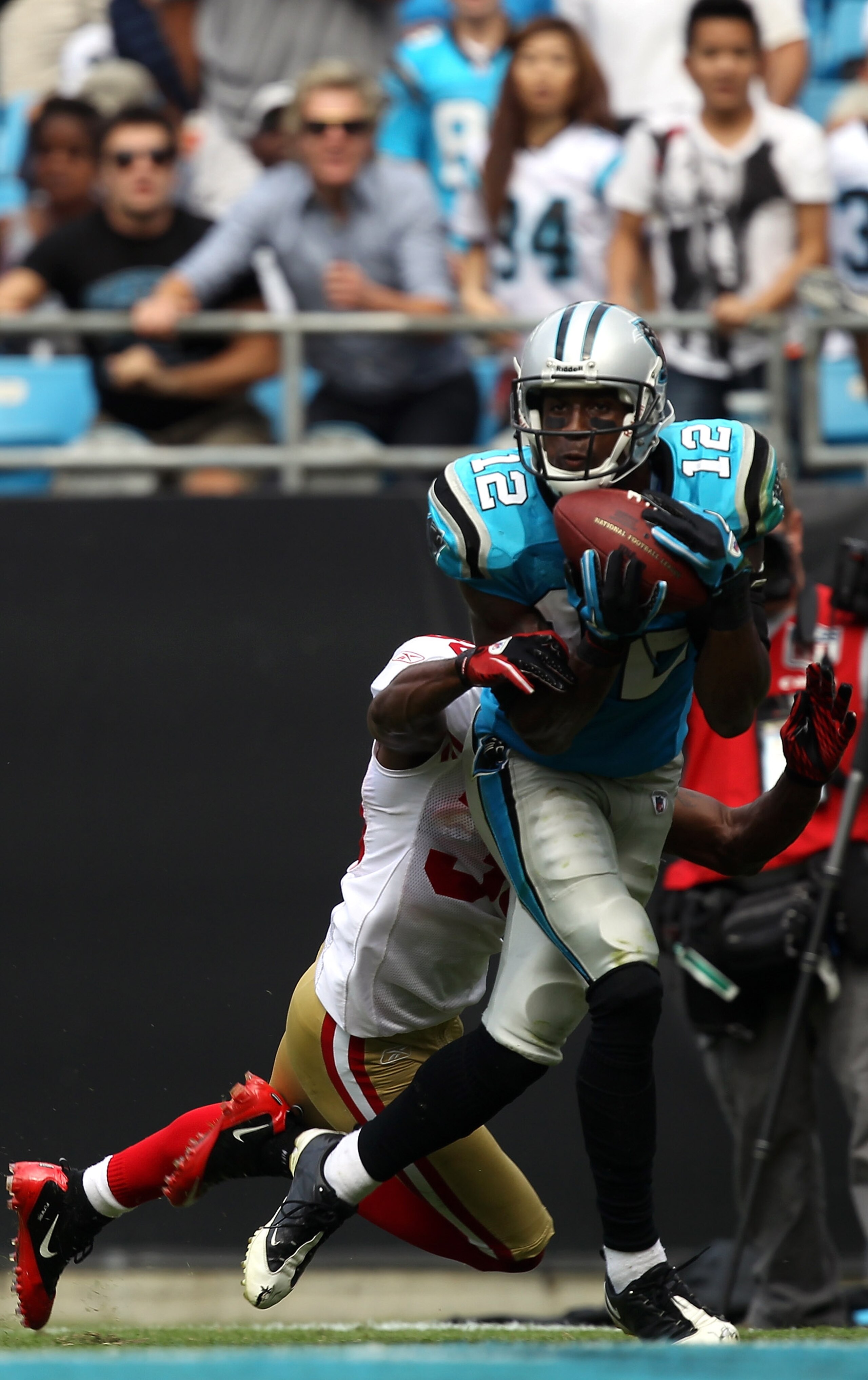 CHARLOTTE, NC - OCTOBER 24:  David Gettis #12 of the Carolina Panthers catches a touchdown late in the fourth quarter against the San Francisco 49ers during their game at Bank of America Stadium on October 24, 2010 in Charlotte, North Carolina.  (Photo by