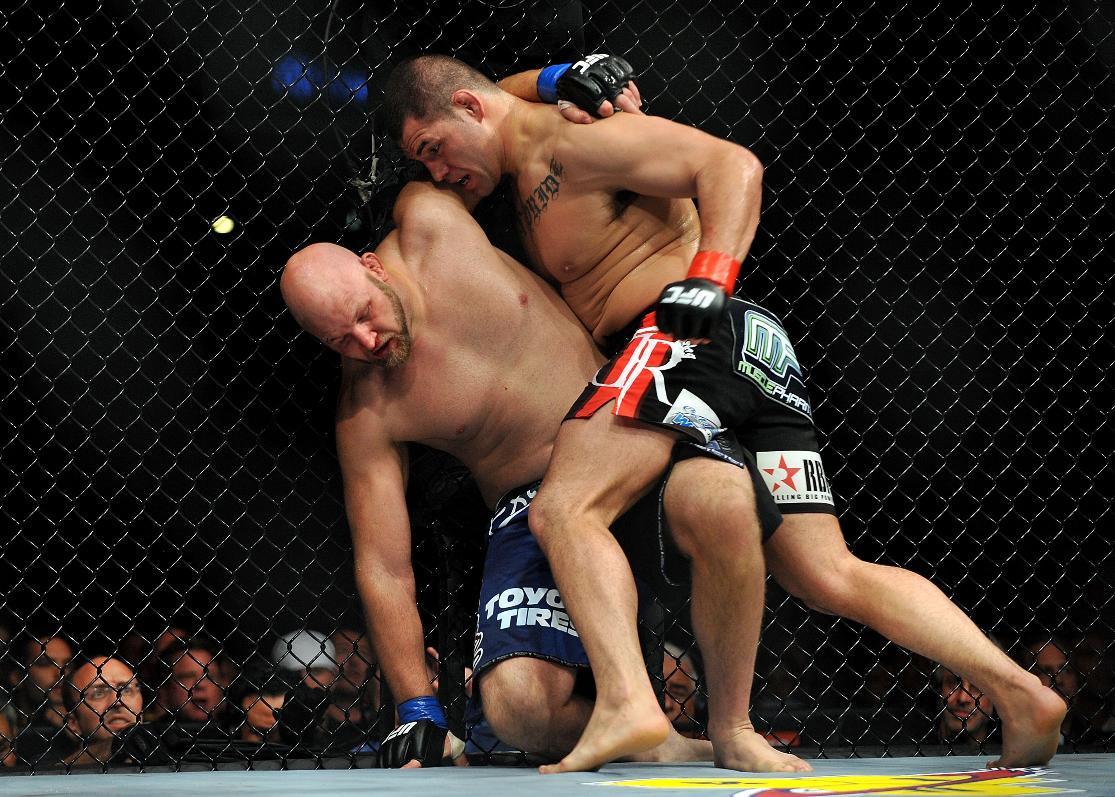 LOS ANGELES, CA - OCTOBER 24:  UFC fighter Cain Velasquez (R) hits UFC fighter Ben Rothwell (L) up against the fence during their Heavyweight bout at UFC 104: Machida vs. Shogun at Staples Center on October 24, 2009 in Los Angeles, California.  Velasquez