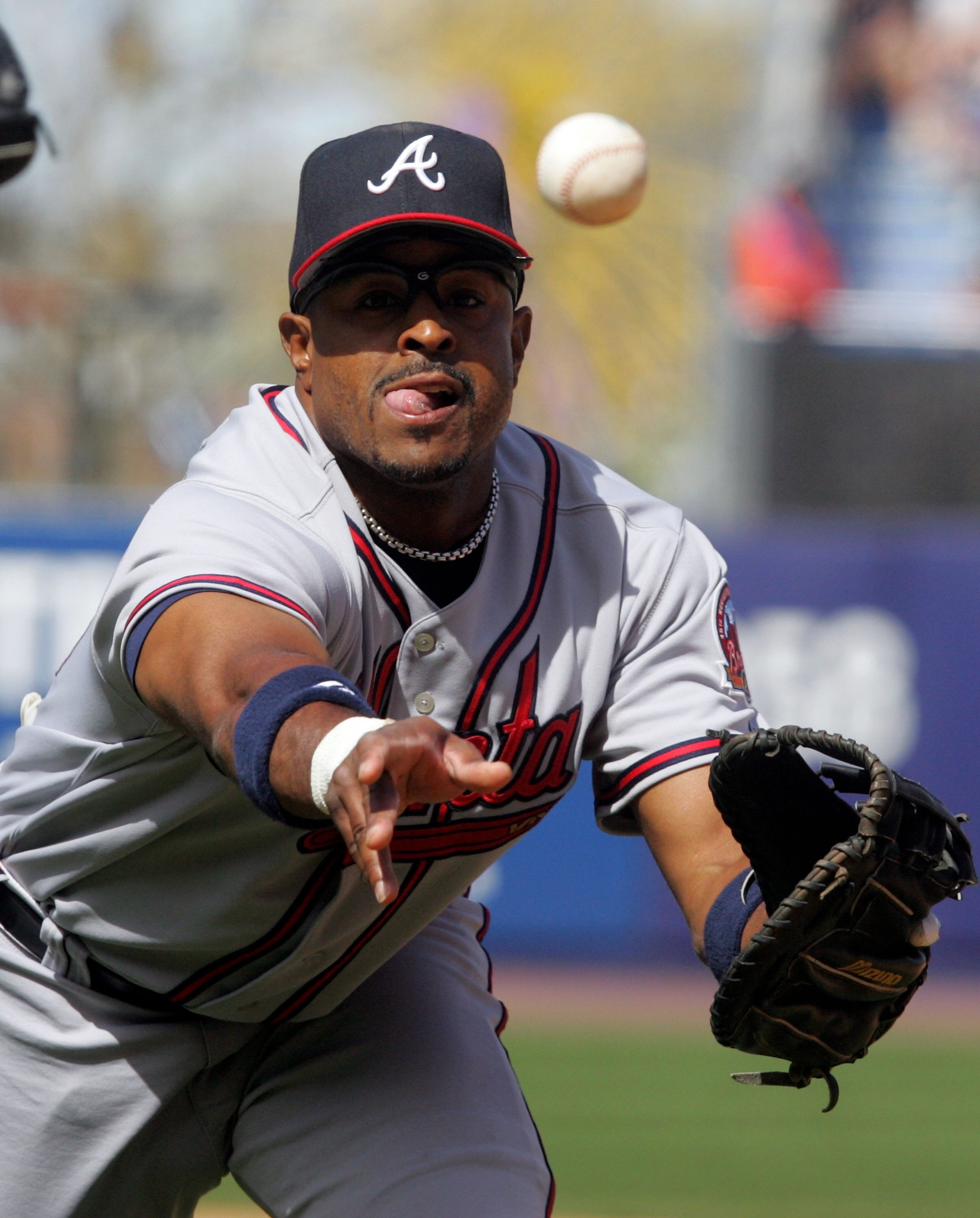 NEW YORK - APRIL 19:  Brian Jordan #33 of the Atlanta Braves tosses the ball to first for an out against the New York Mets on April 19, 2006 at Shea Stadium in the Flushing neighborhood of the Queens borough of New York City.The Braves defeated the Mets 2