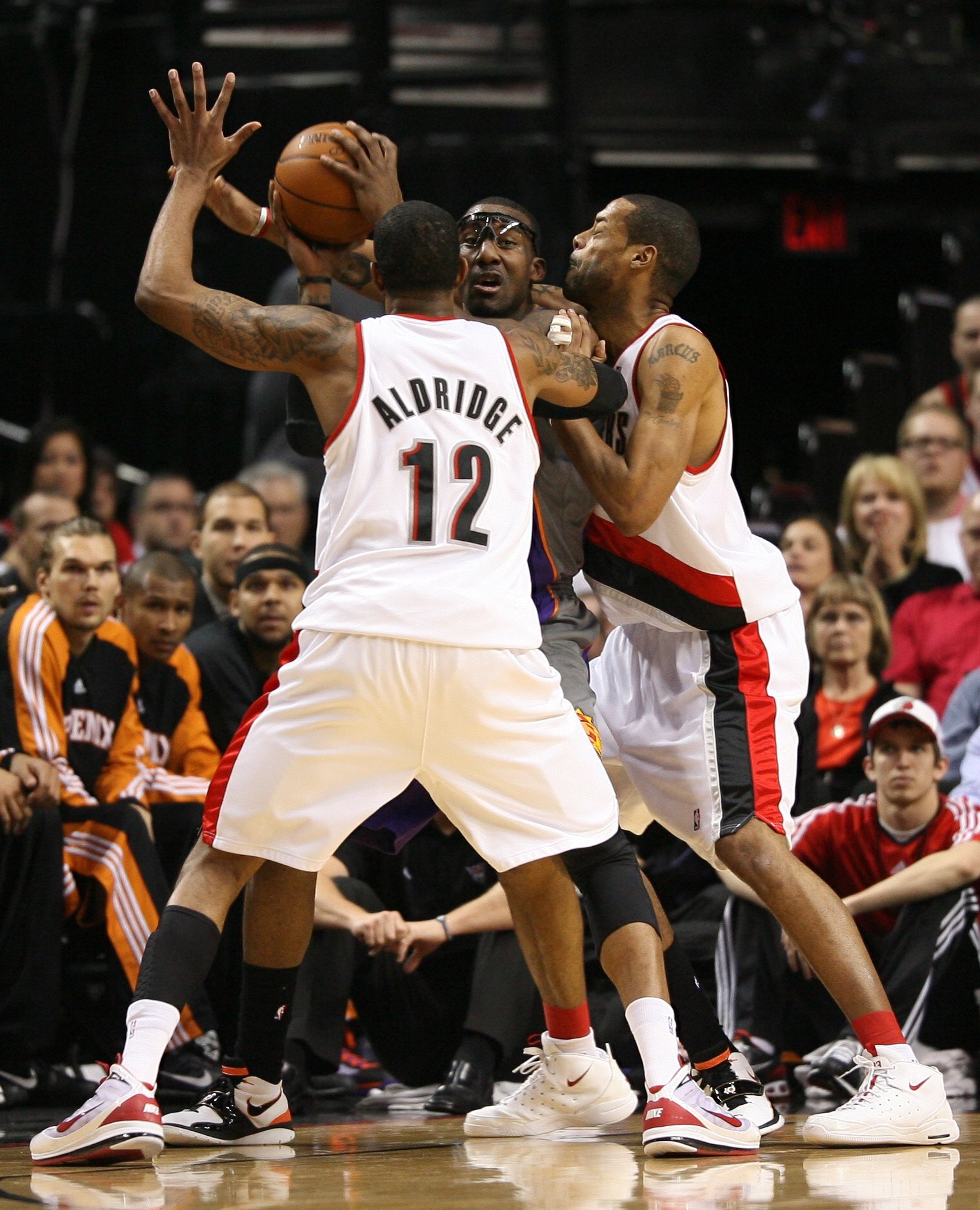 PORTLAND, OR - APRIL 29:  Amare Stoudemire #1 of the Phoenix Suns is swarmed by LaMarcus Aldridge #12 and Marcus Camby #21 of the Portland Trail Blazers during Game Six of the Western Conference Quarterfinals of the NBA Playoffs on April 29, 2010 at the R