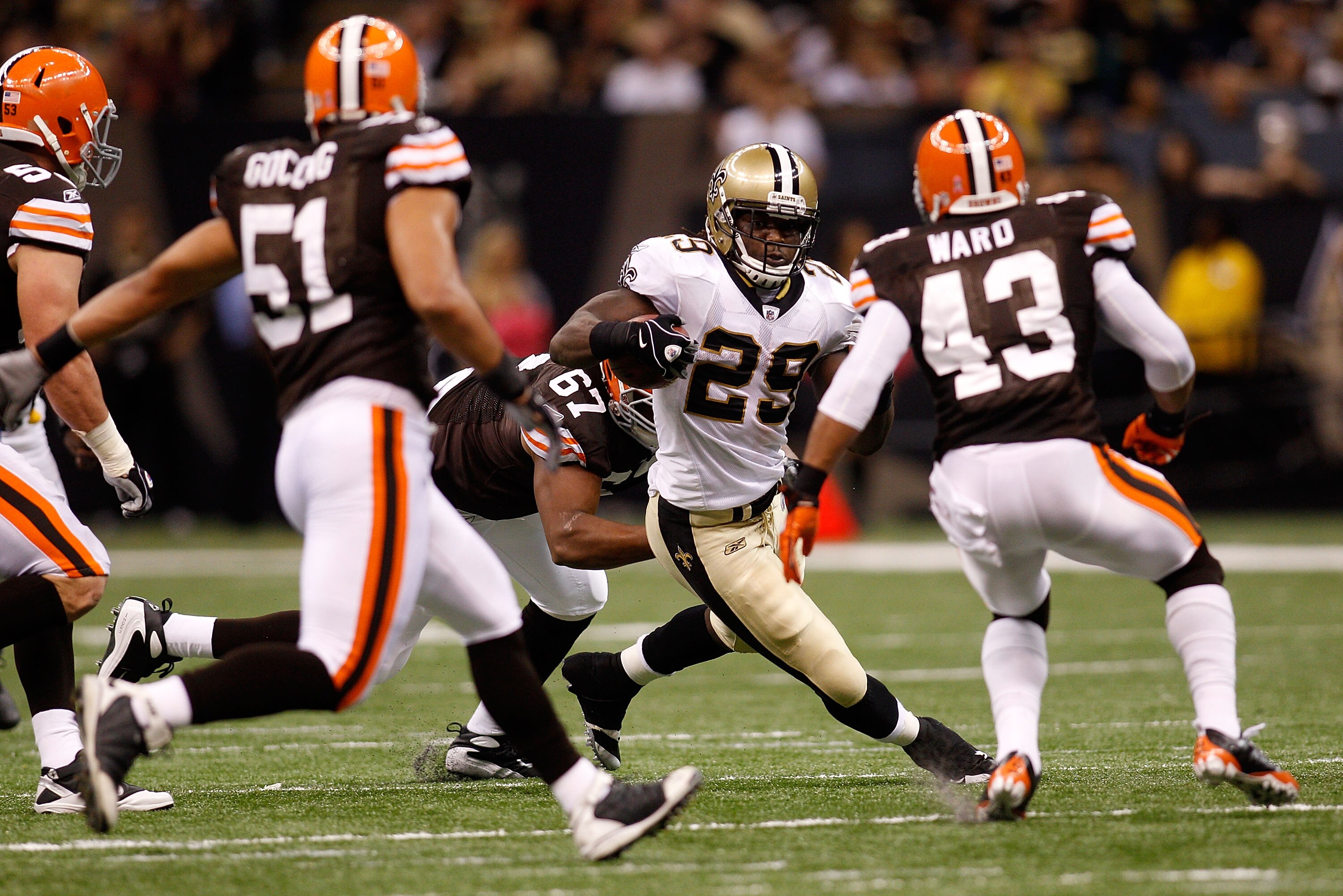 NEW ORLEANS - OCTOBER 24:  Chris Ivory #29 of the New Orleans Saints avoids a tackle by Derreck Robinson #67 and T.J. Ward #43 of the Cleveland Browns at the Louisiana Superdome on October 24, 2010 in New Orleans, Louisiana.  (Photo by Chris Graythen/Gett