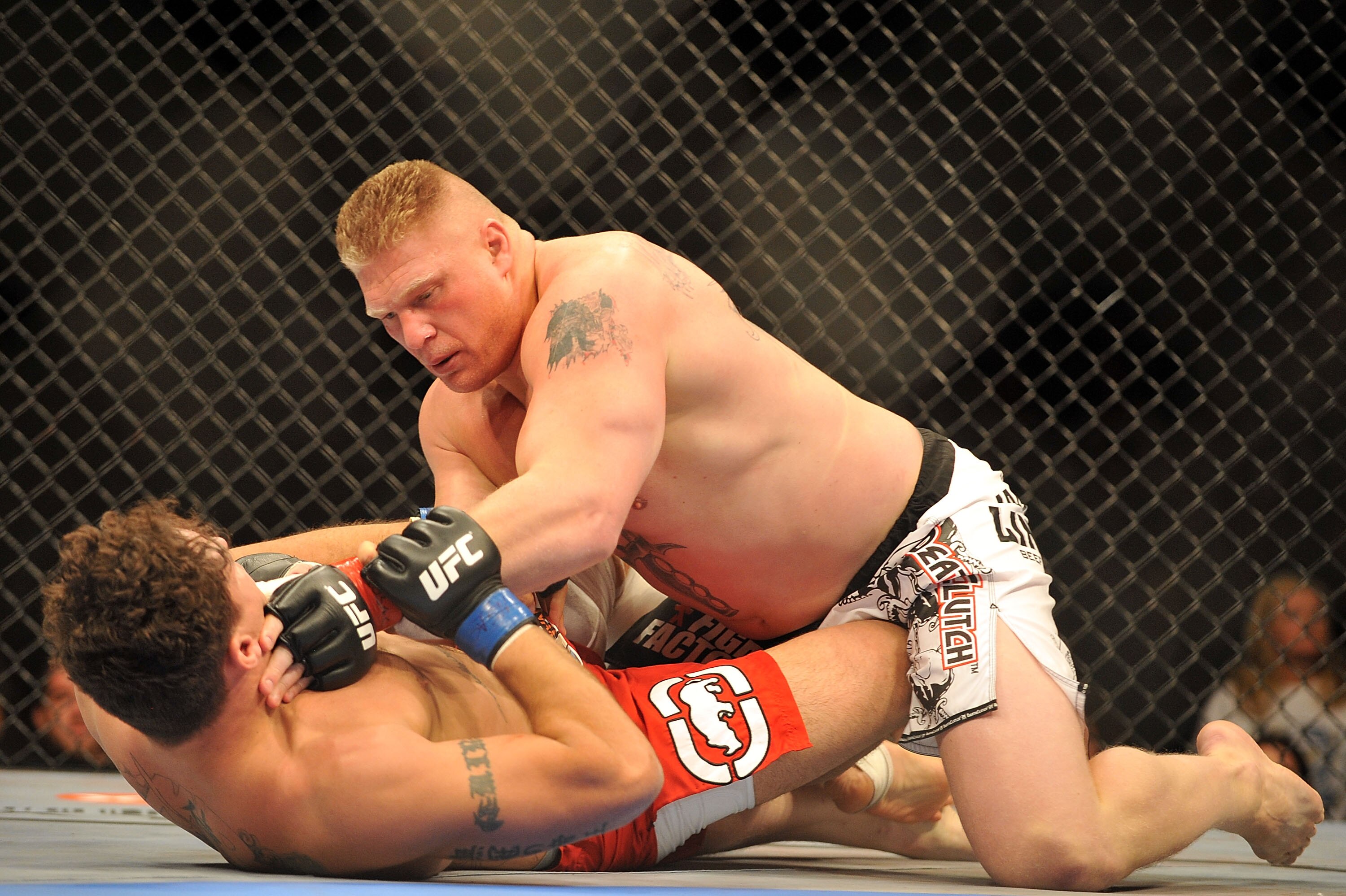 LAS VEGAS - JULY 11:  Brock Lesnar holds down Frank Mir during their heavyweight title bout during UFC 100 on July 11, 2009 in Las Vegas, Nevada. Lesnar defeated Mir by a second round knockout.  (Photo by Jon Kopaloff/Getty Images)