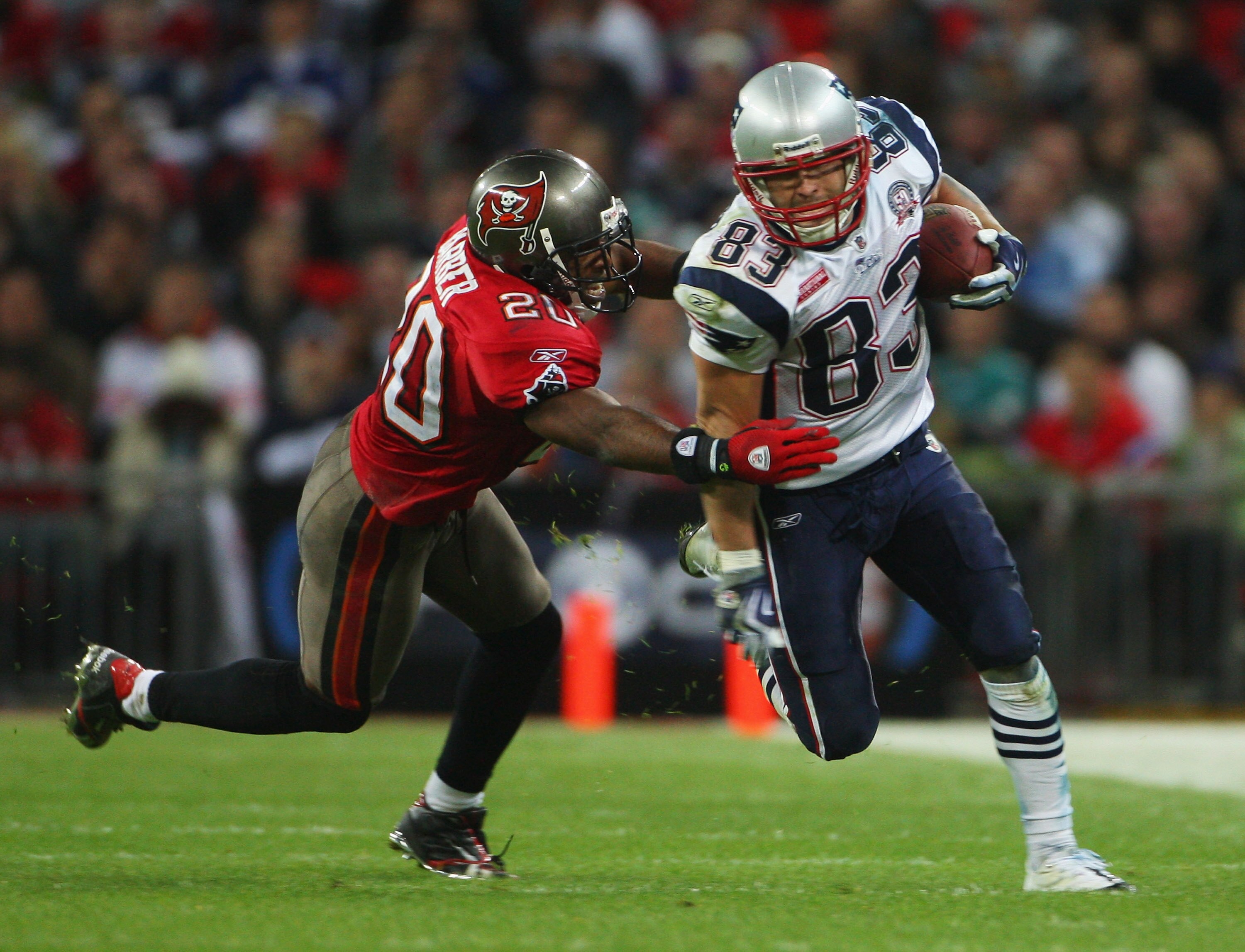 LONDON, ENGLAND - OCTOBER 25:  Wes Welker (#83) of the New England Patriots is tackled by Ronde Barber (#20) of Tampa Bay Buccaneers  during the NFL International Series match between New England Patriots and Tampa Bay Buccaneers at Wembley Stadium on Oct