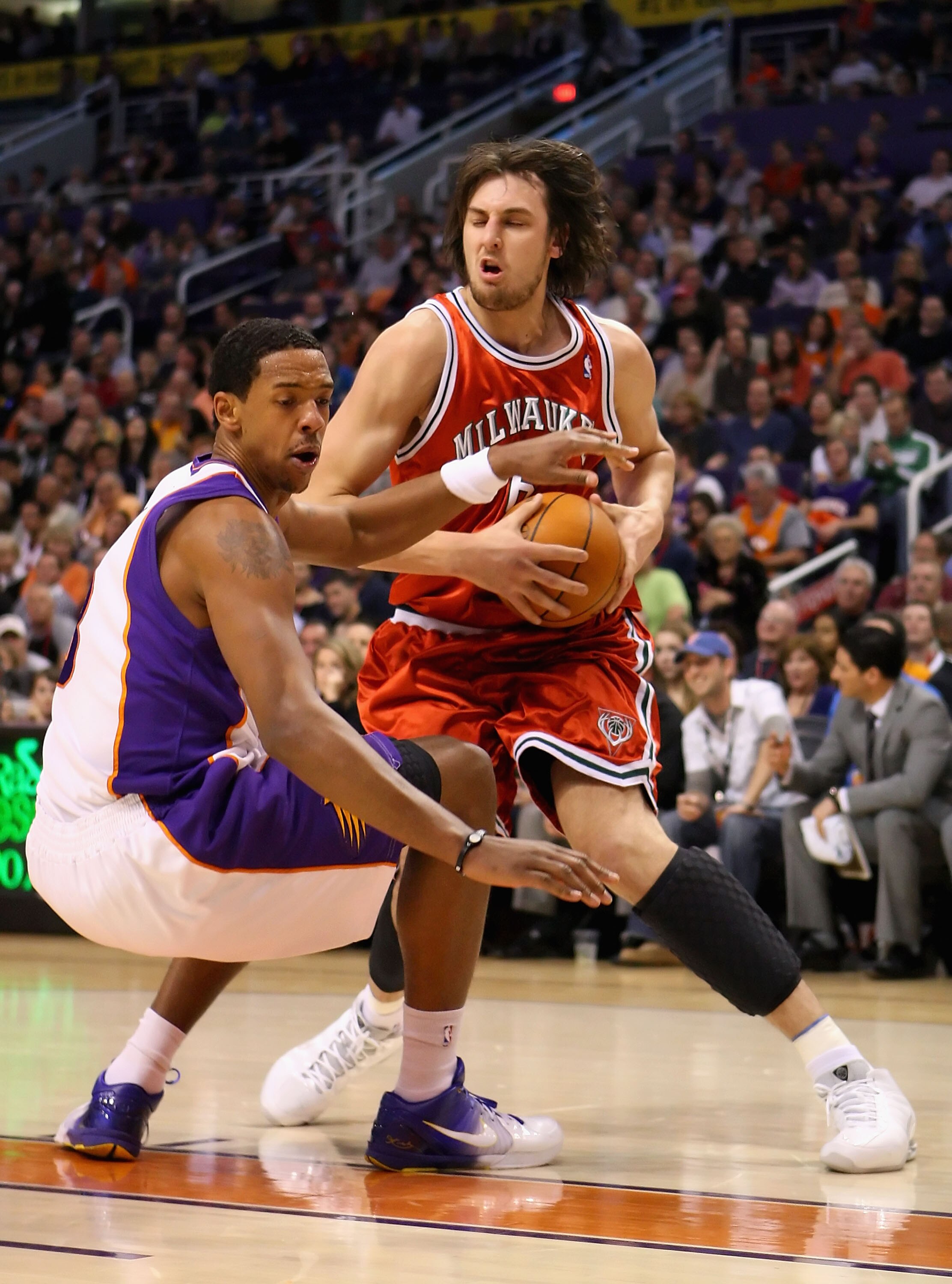 PHOENIX - JANUARY 11:  Andrew Bogut #6 of the Milwaukee Bucks collides into Channing Frye #8 of the Phoenix Suns during the NBA game at US Airways Center on January 11, 2010 in Phoenix, Arizona. The Suns defeated the Bucks 105-101.  NOTE TO USER: User exp