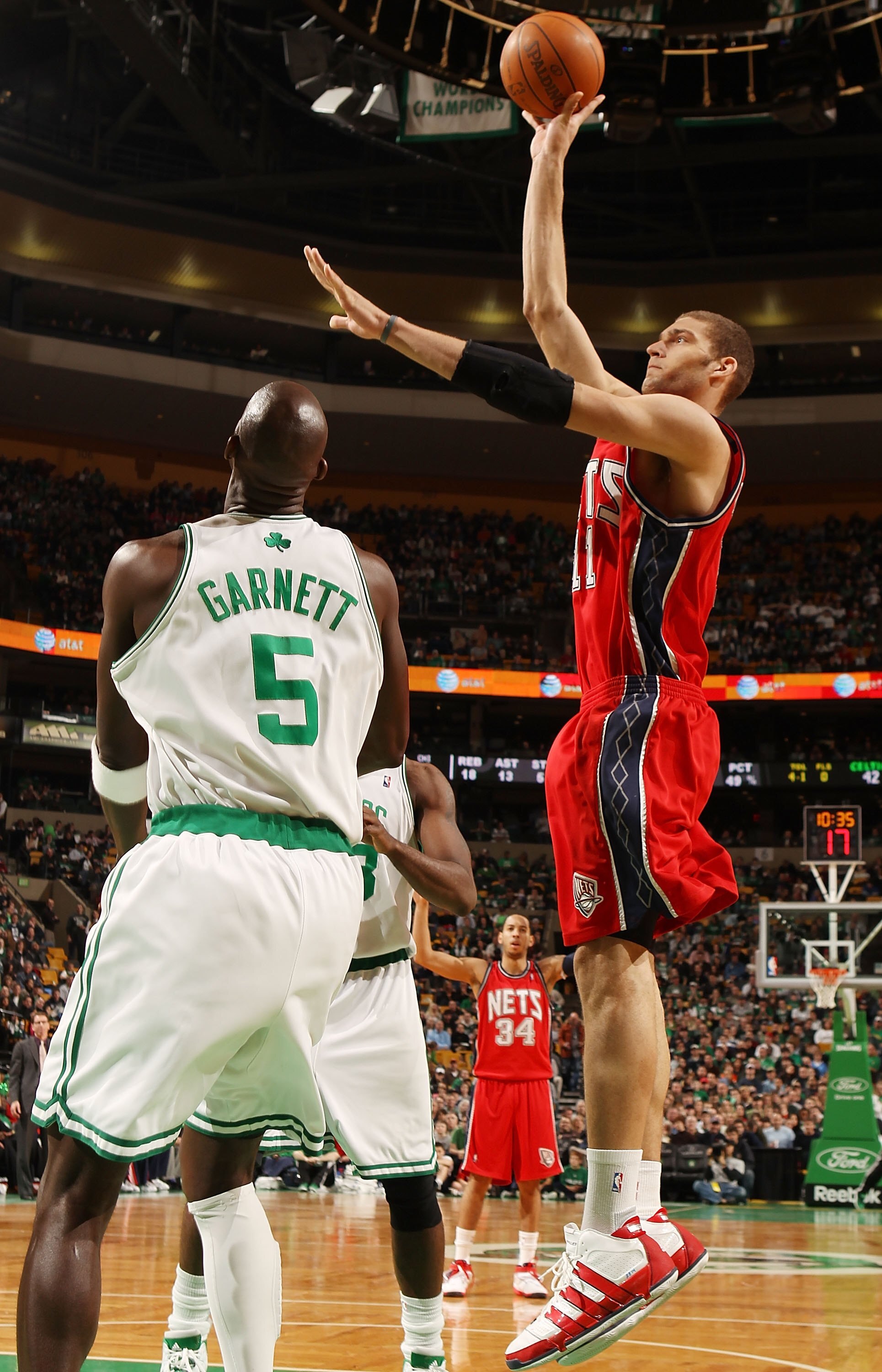 BOSTON - FEBRUARY 27:  Brook Lopez #11 of the New Jersey Nets takes a shot as Kevin Garnett #5 of the Boston Celtics defends at the TD Garden on February 27, 2010 in Boston, Massachusetts. The Nets defeated the Celtics 104-96.  NOTE TO USER: User expressl