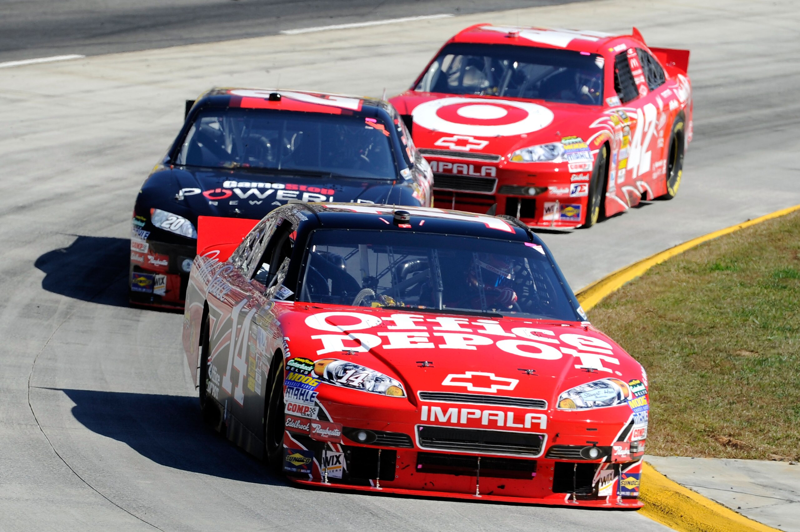 MARTINSVILLE, VA - OCTOBER 24:  Tony Stewart, driver of the #14 Old Spice/Office Depot Chevrolet, leads Joey Logano, driver of the #20 GameStop PowerUp Rewards Toyota, and Juan Pablo Montoya, driver of the #42 Target Chevrolet, during the NASCAR Sprint Cu