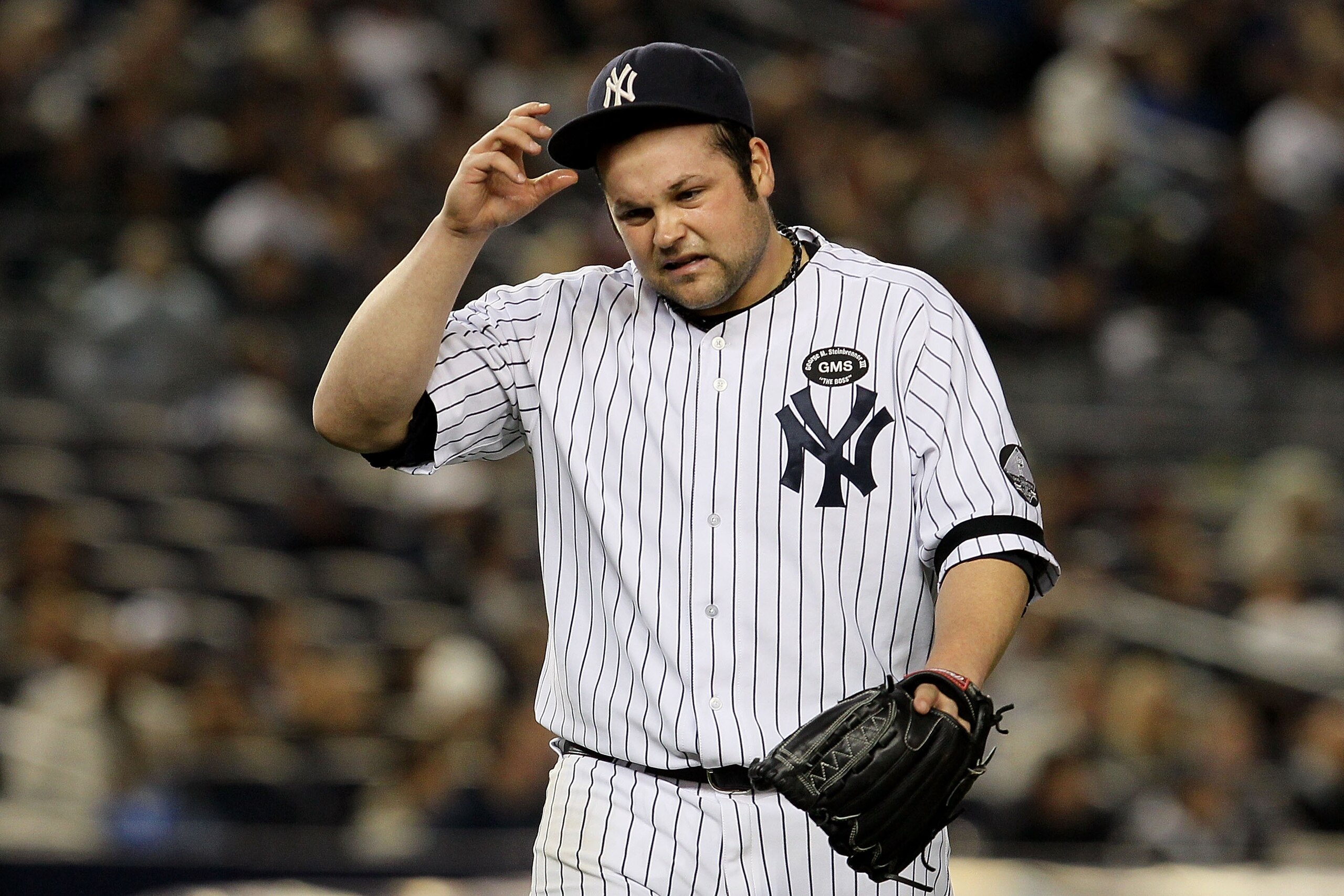 NEW YORK - OCTOBER 19:  Joba Chamberlain #62 of the New York Yankees reacts as he walks back to the dugout at the end of the top of the eighth inning against the Texas Rangers in Game Four of the ALCS during the 2010 MLB Playoffs at Yankee Stadium on Octo