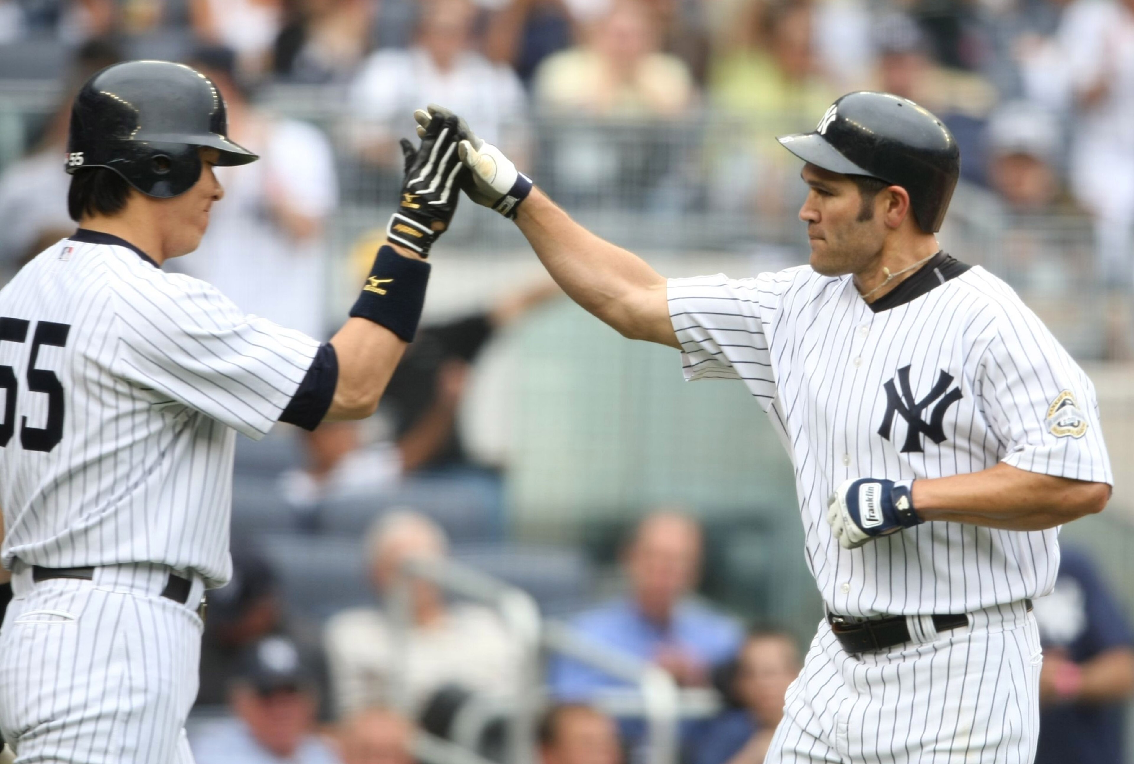 NEW YORK - AUGUST 12:  Johnny Damon #2 (R) of the New York Yankees gets a high five from teammate Hideki Matsui #55 after hitting a homerun in the third inning during the MLB game against the Toronto Blue Jays on August 12, 2009 at Yankee Stadium in the B