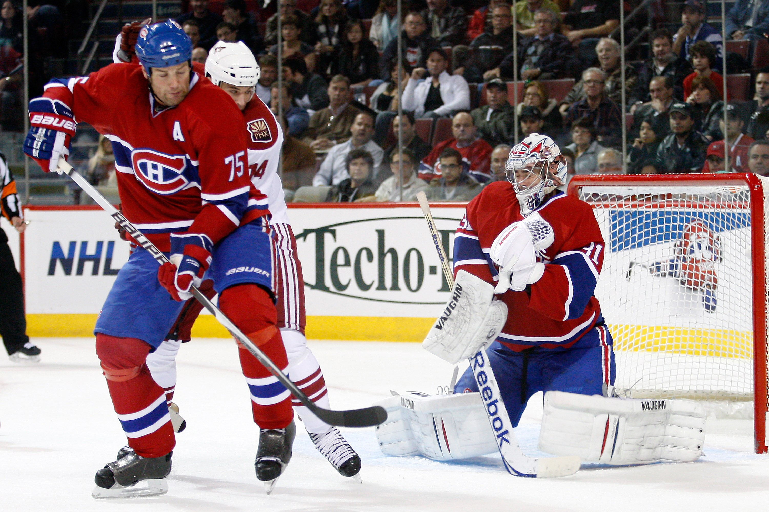 MONTREAL, CANADA - OCTOBER 25:  Carey Price #31 of the Montreal Canadiens stops the puck in front of team mate Hal Gill #75 and Taylor Pyatt #14 of the Phoenix Coyotes during the NHL game at the Bell Centre on October 25, 2010 in Montreal, Quebec, Canada.