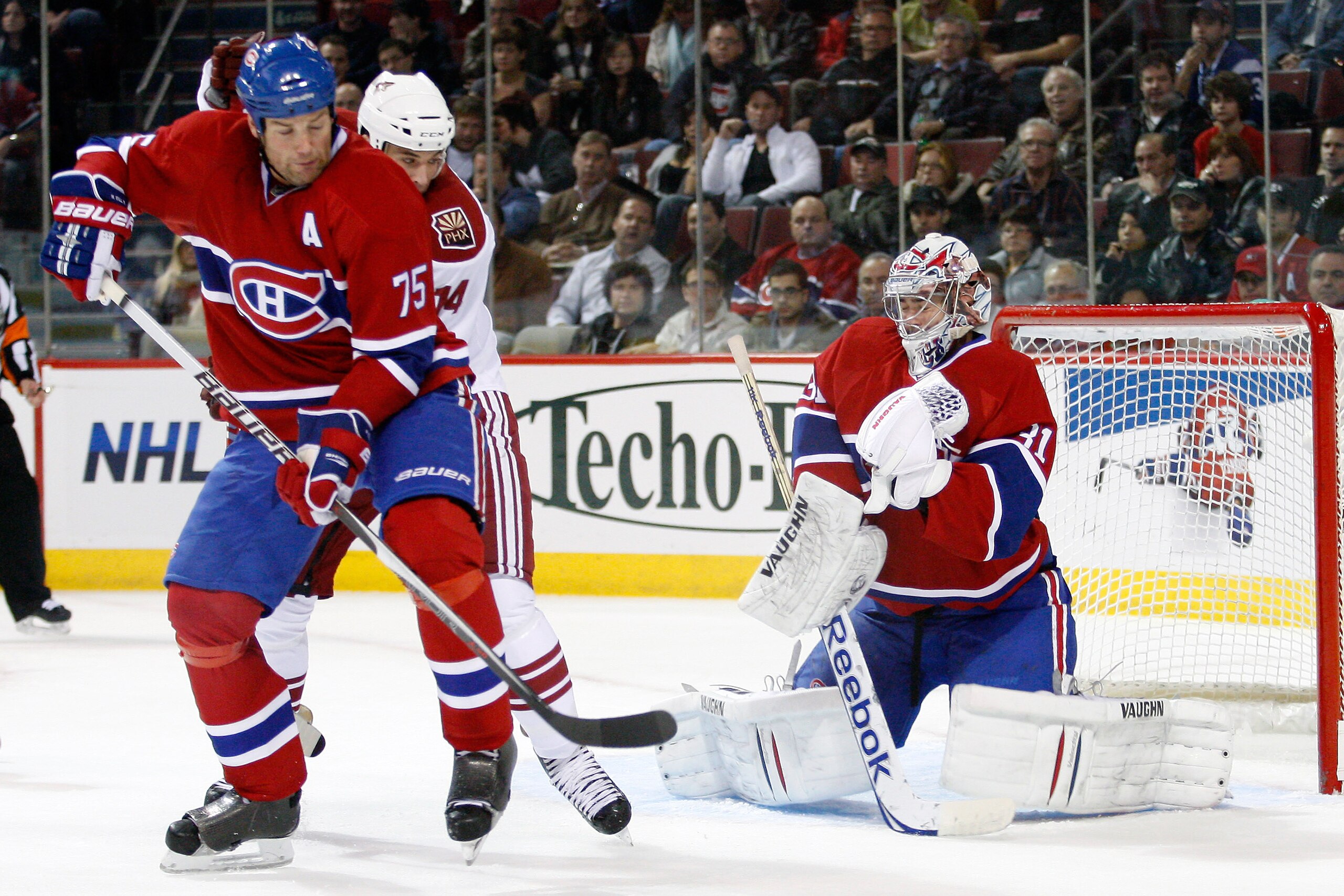 MONTREAL, CANADA - OCTOBER 25:  Carey Price #31 of the Montreal Canadiens stops the puck in front of team mate Hal Gill #75 and Taylor Pyatt #14 of the Phoenix Coyotes during the NHL game at the Bell Centre on October 25, 2010 in Montreal, Quebec, Canada.
