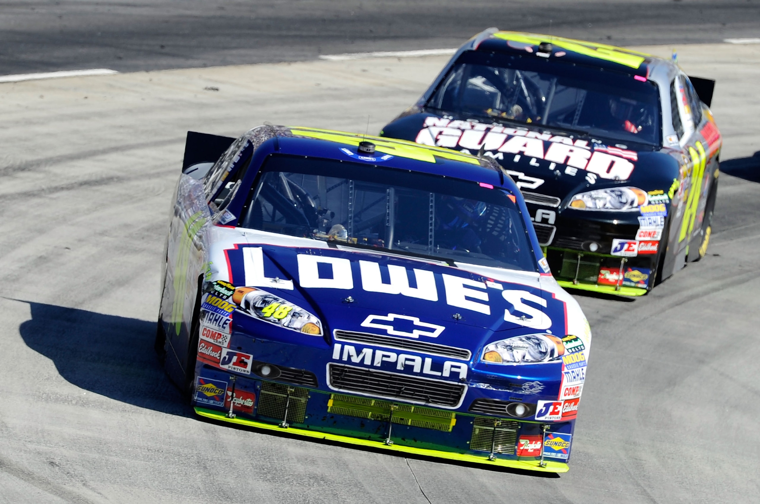 MARTINSVILLE, VA - OCTOBER 24:  Jimmie Johnson, driver of the #48 Lowe's Chevrolet,  leads Jeff Gordon, driver of the #24 DuPont/National Guard Families Chevrolet, during the NASCAR Sprint Cup Series TUMS Fast Relief 500 at Martinsville Speedway on Octobe
