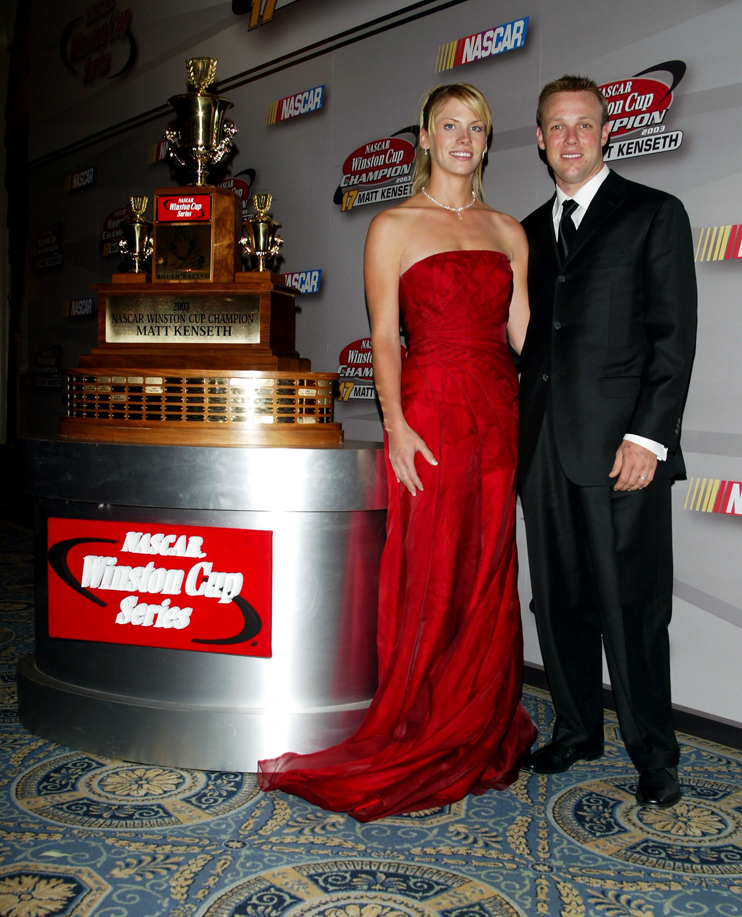 NEW YORK - DECEMBER 05: NASCAR driver Matt Kenseth and wife Katie pose with 1st place trophy in the press room during the 2003 NASCAR Winston Cup Awards at the Waldorf Astoria Hotel December 05, 2003 in New York City.   (Photo by Matthew Peyton/Getty Imag