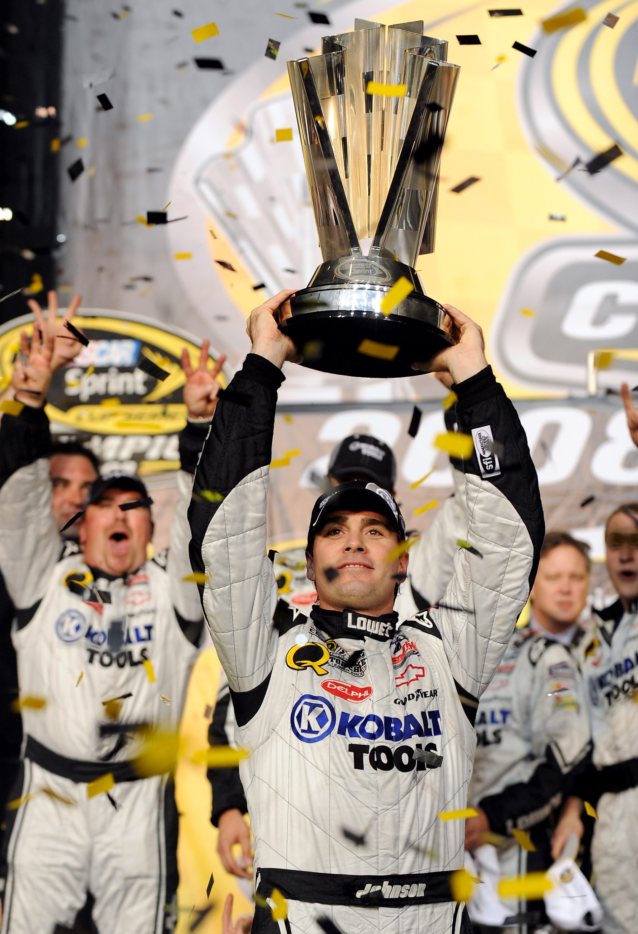 HOMESTEAD, FL - NOVEMBER 16:  Jimmie Johnson (R), driver of the #48 Lowe's/Kobalt Tools Chevrolet, holds up the trophy after winning the 2008 NASCAR Sprint Cup Series Championship after the Ford 400 at Homestead-Miami Speedway on November 16, 2008 in Home